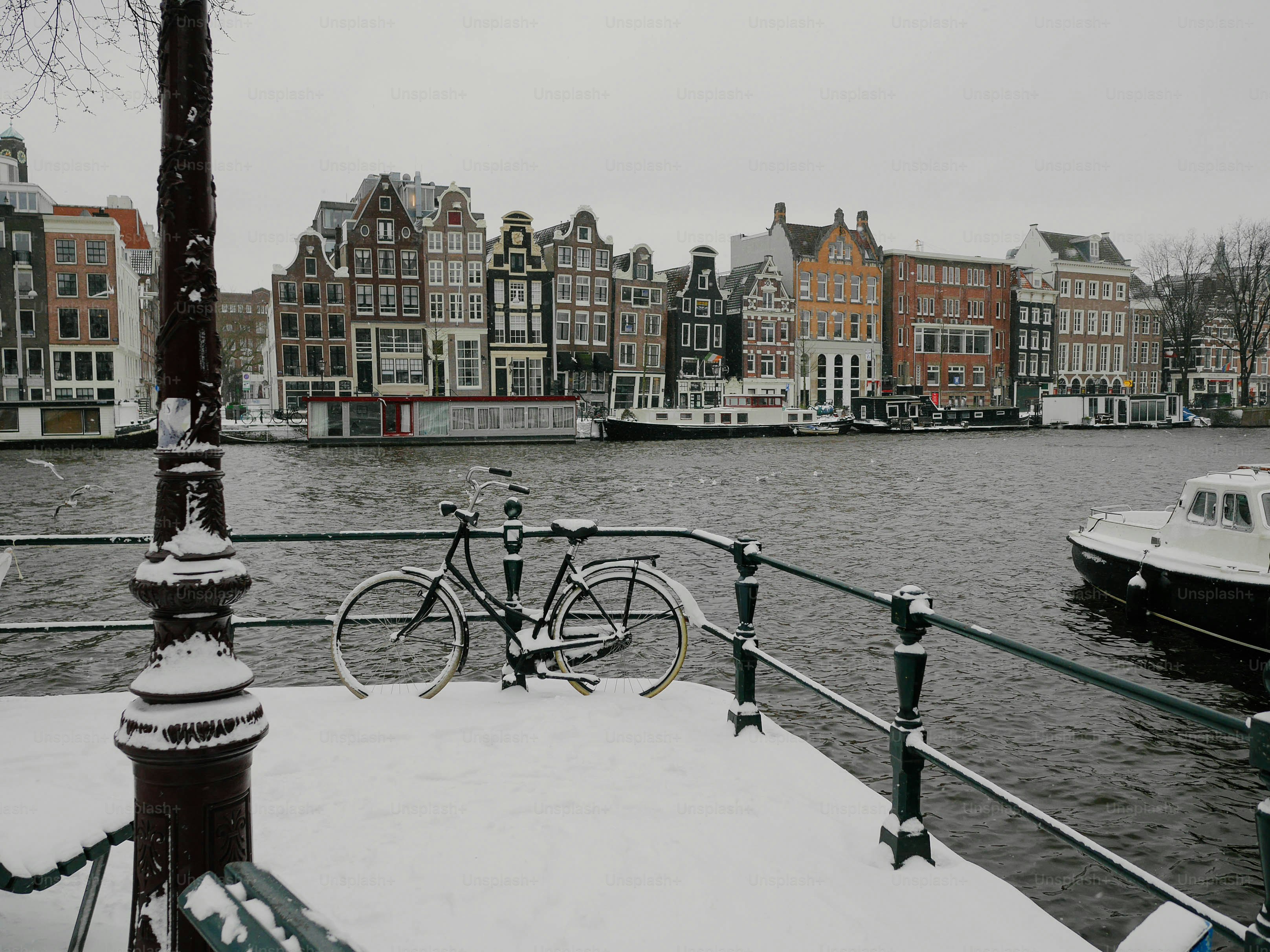 A bicycle is parked on a railing next to a body of water