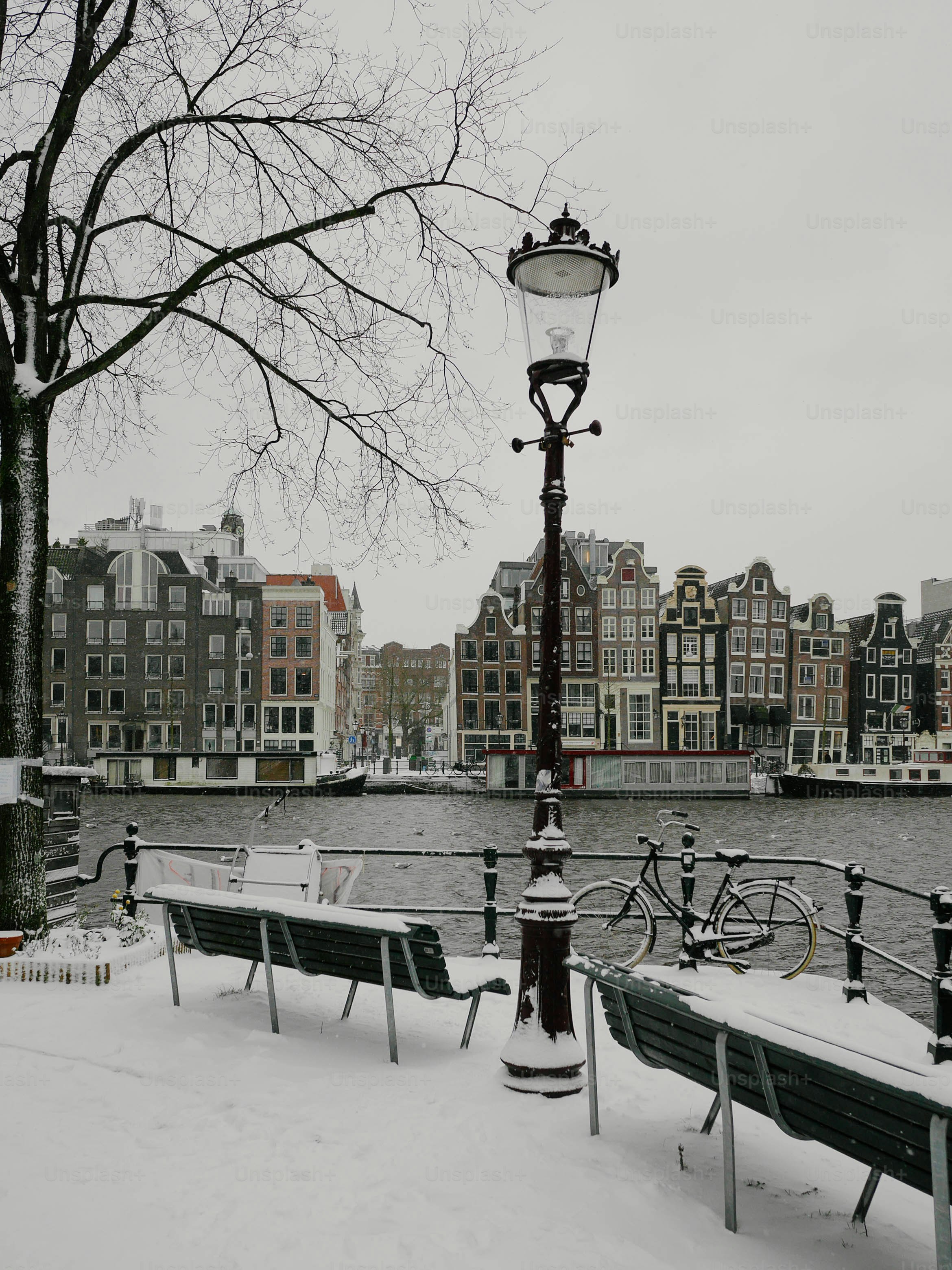 A couple of benches sitting on top of a snow covered ground