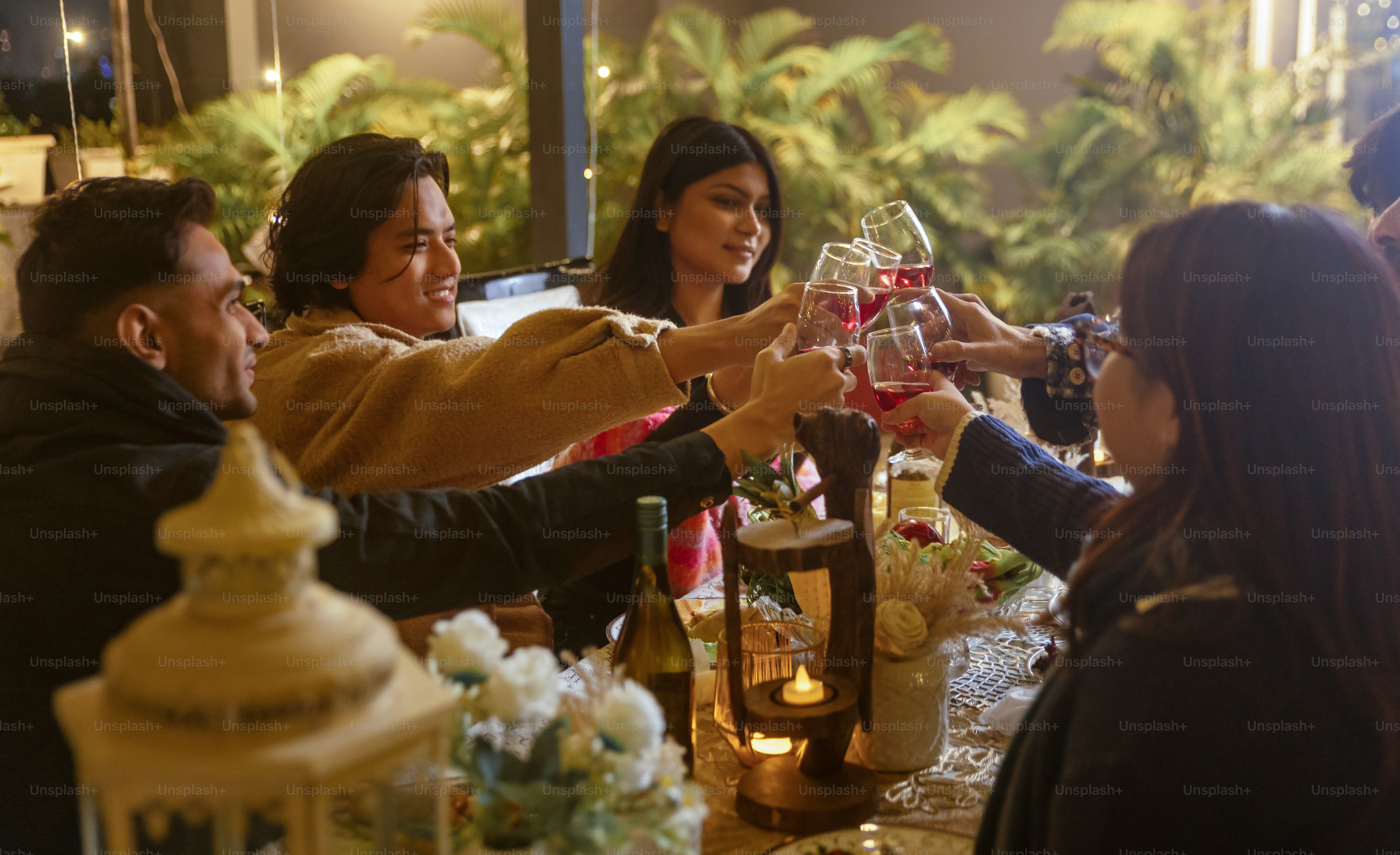 A group of people sitting around a table drinking wine photo – Food ...