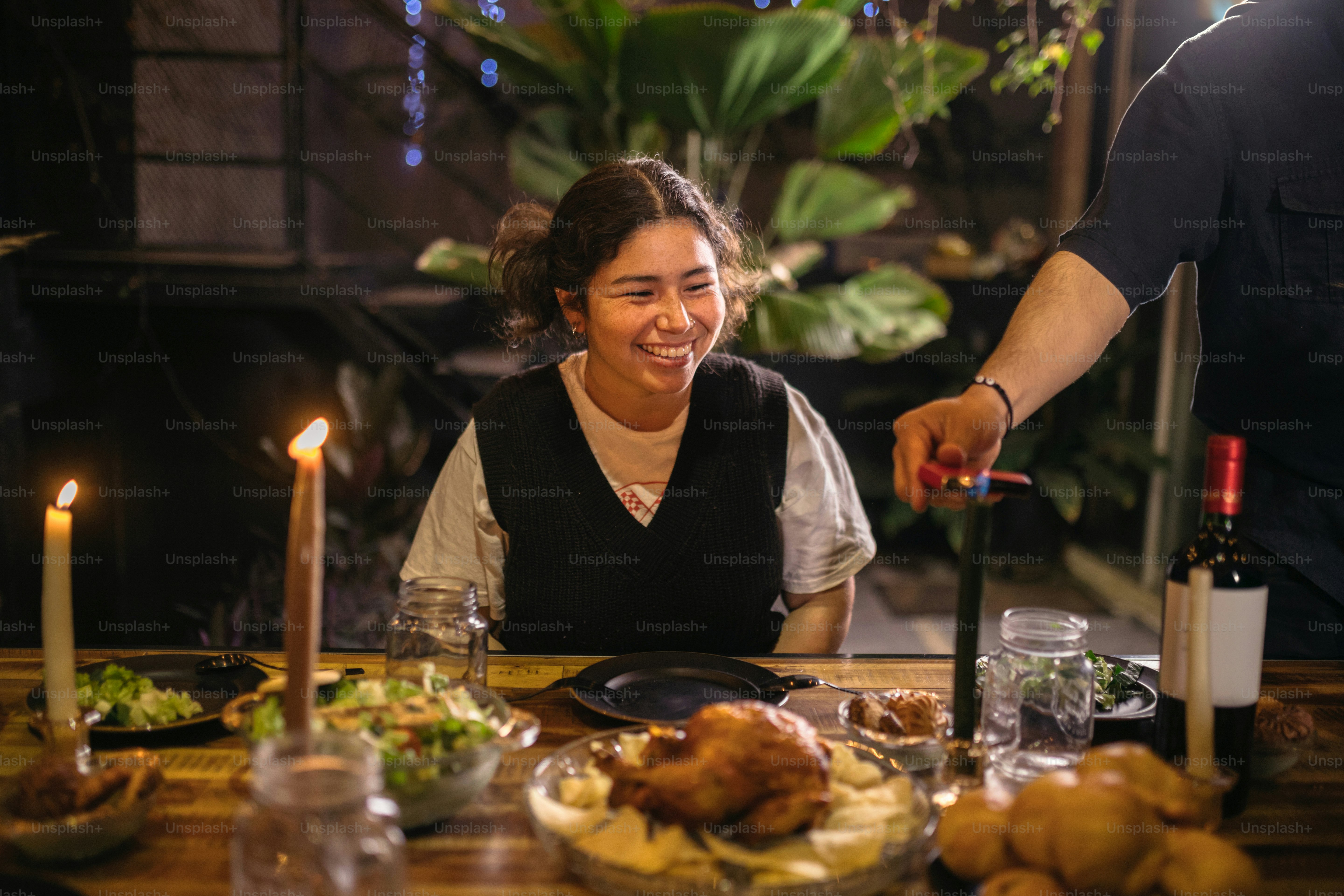 A woman sitting at a table with a knife in her hand
