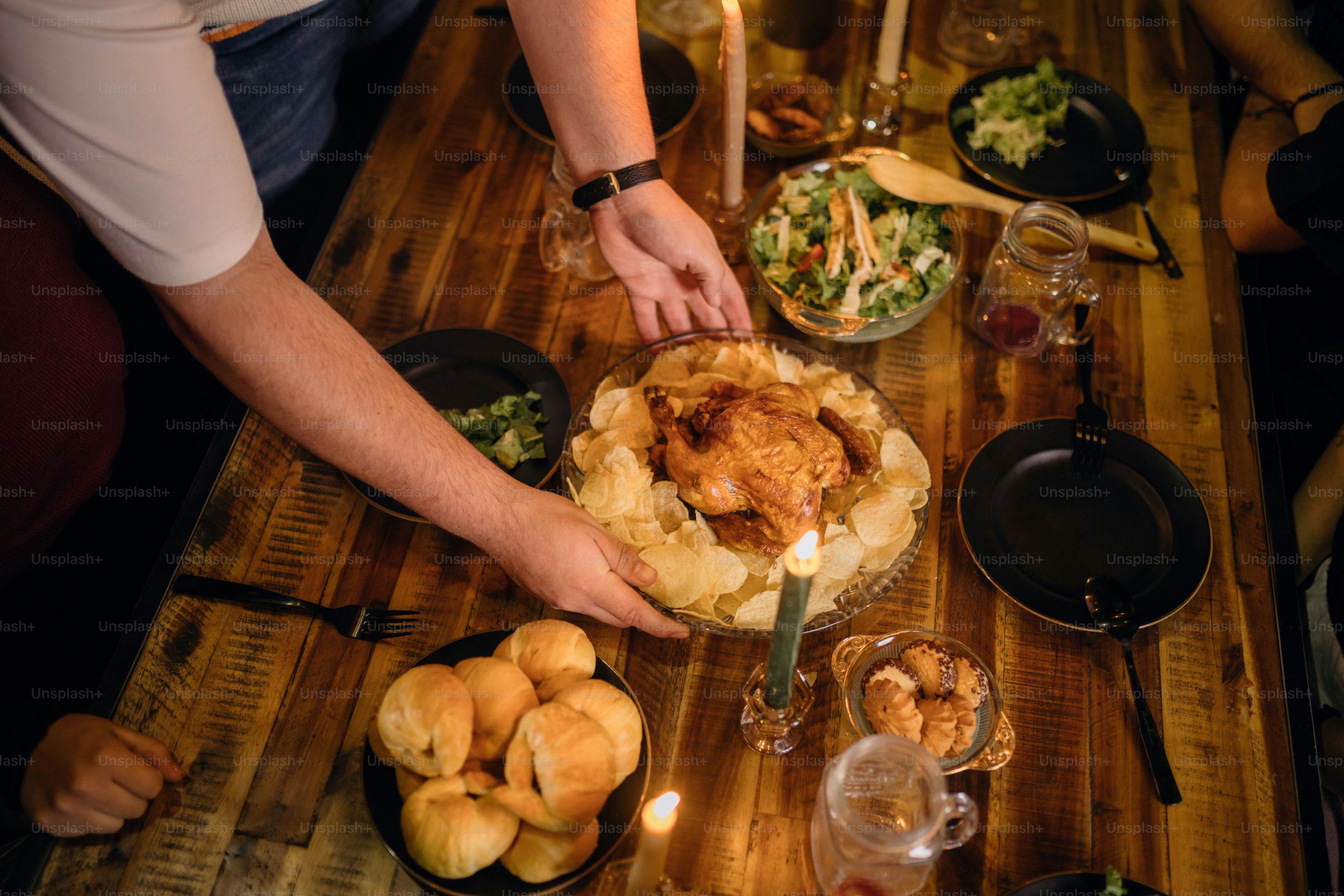 A group of people standing around a wooden table