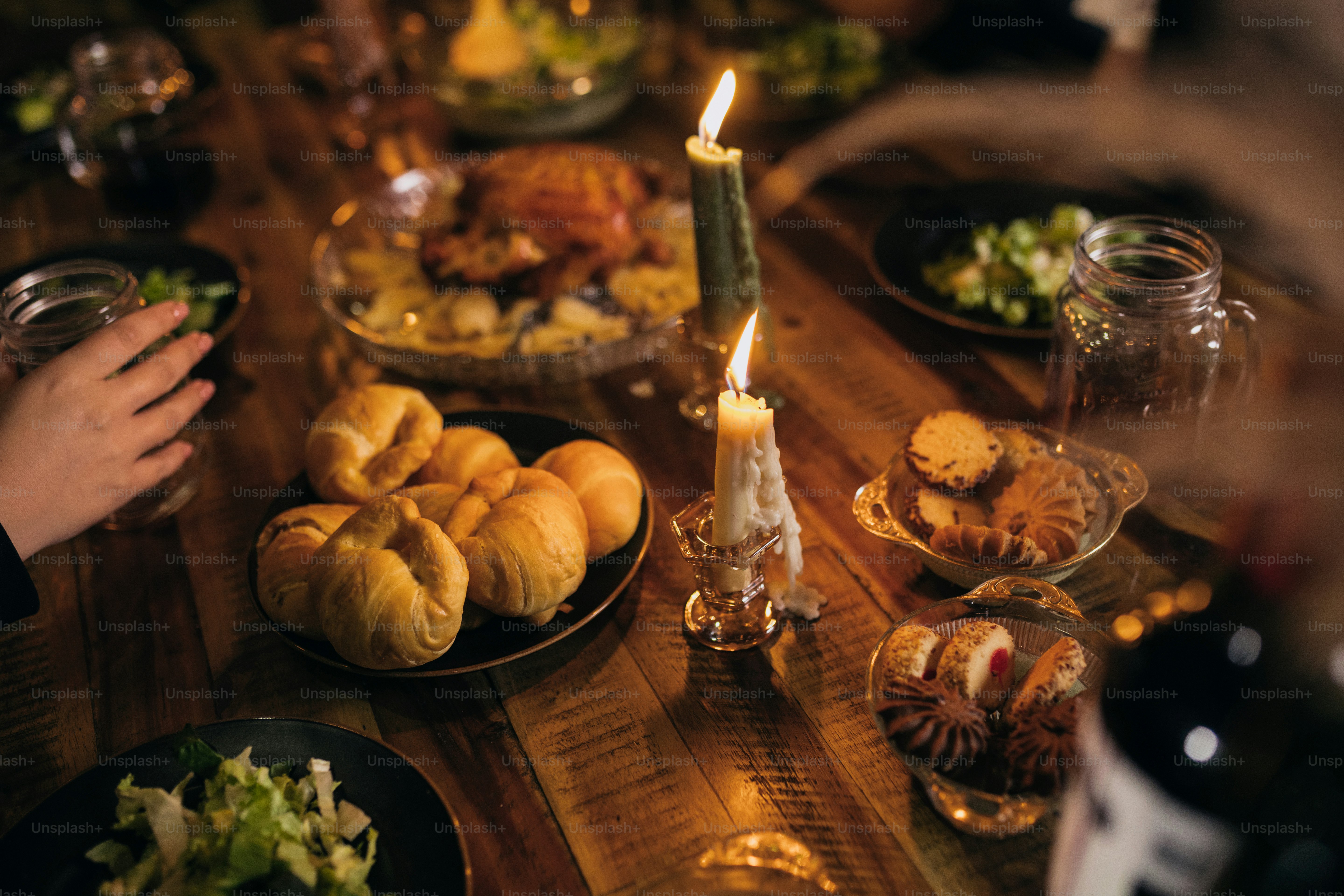 A group of people sitting around a table with food