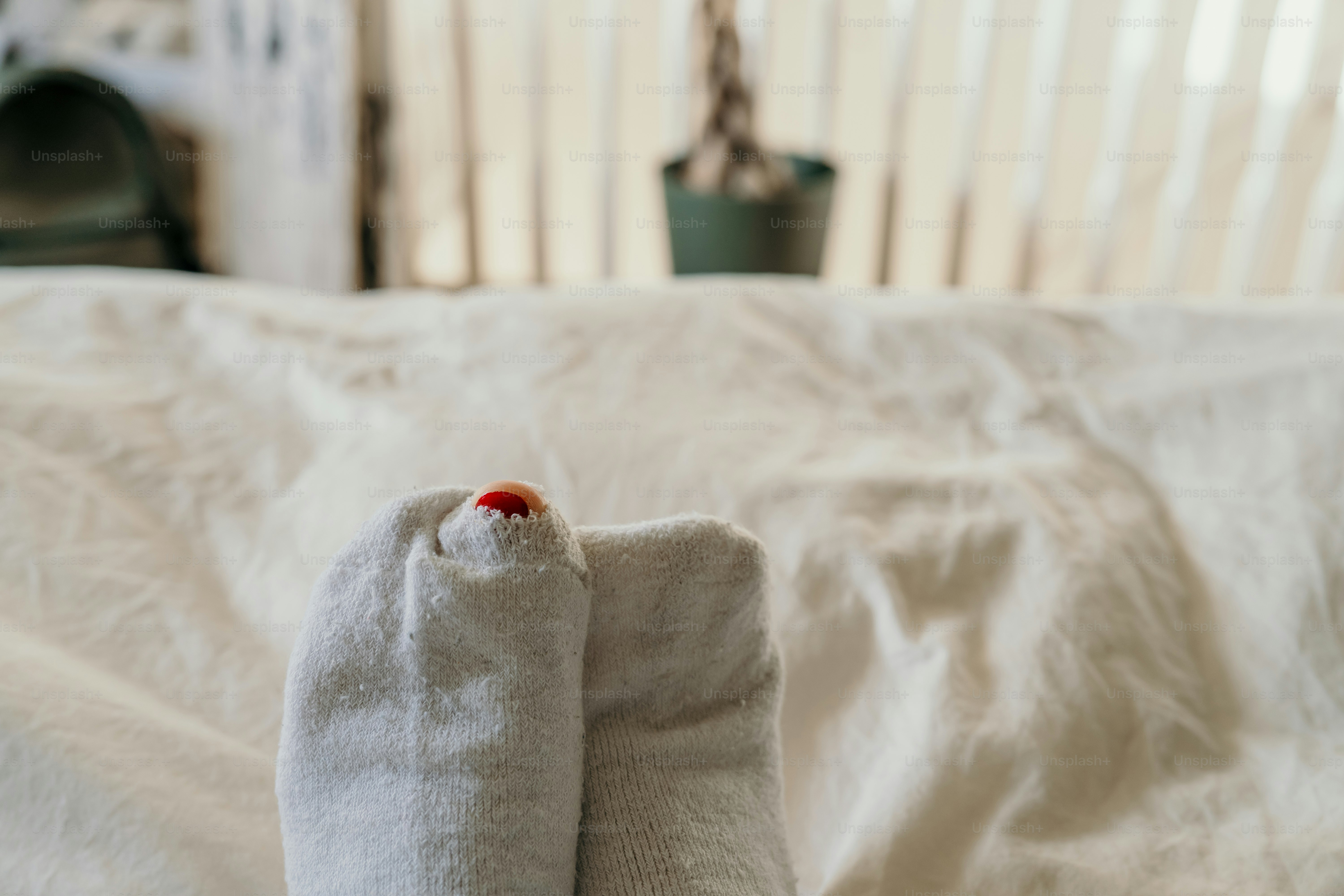 A pair of white socks sitting on top of a bed