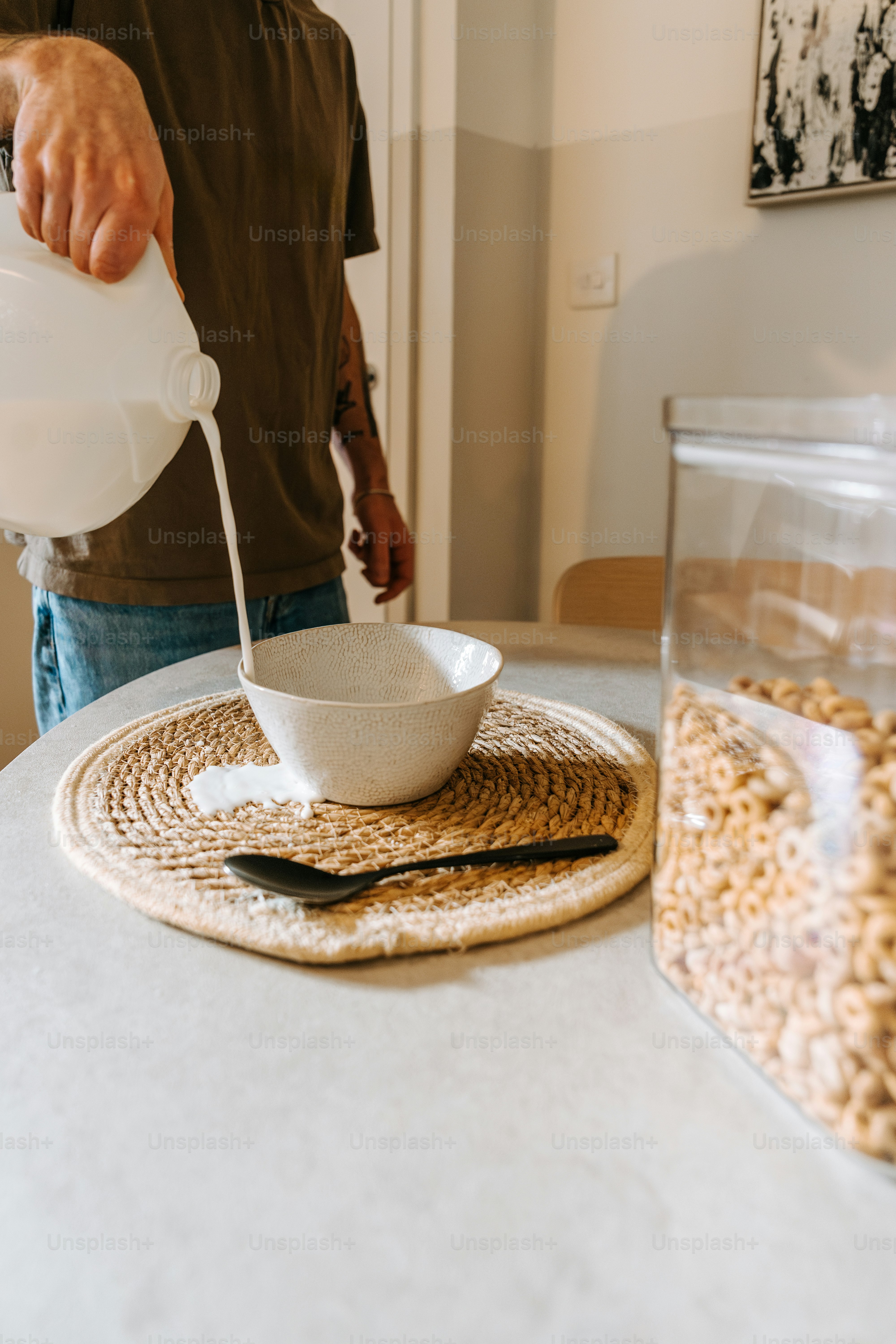 A man pouring a bowl of cereal into a bowl