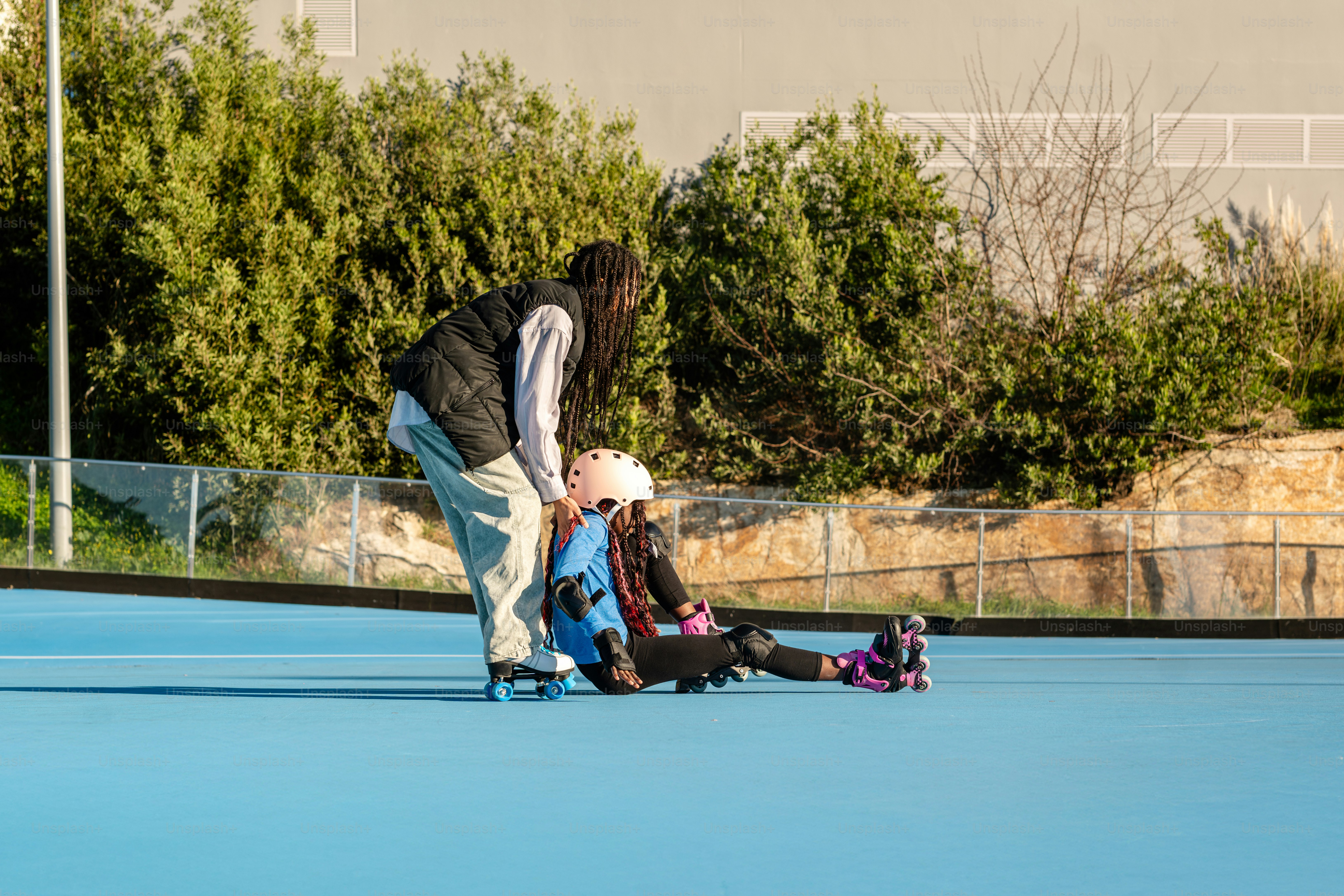 A man and two children on a tennis court