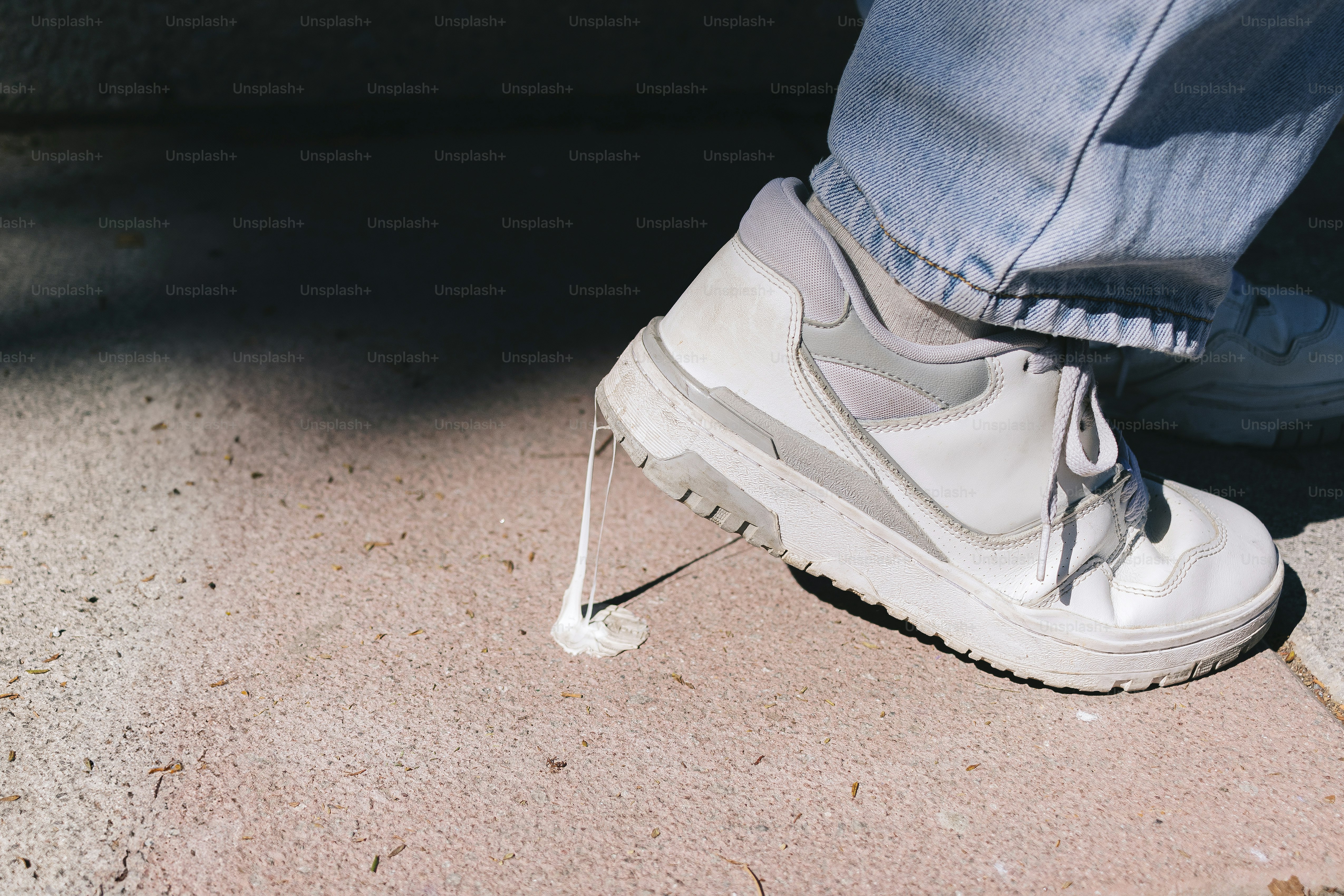 A person standing on the ground with their foot in the air