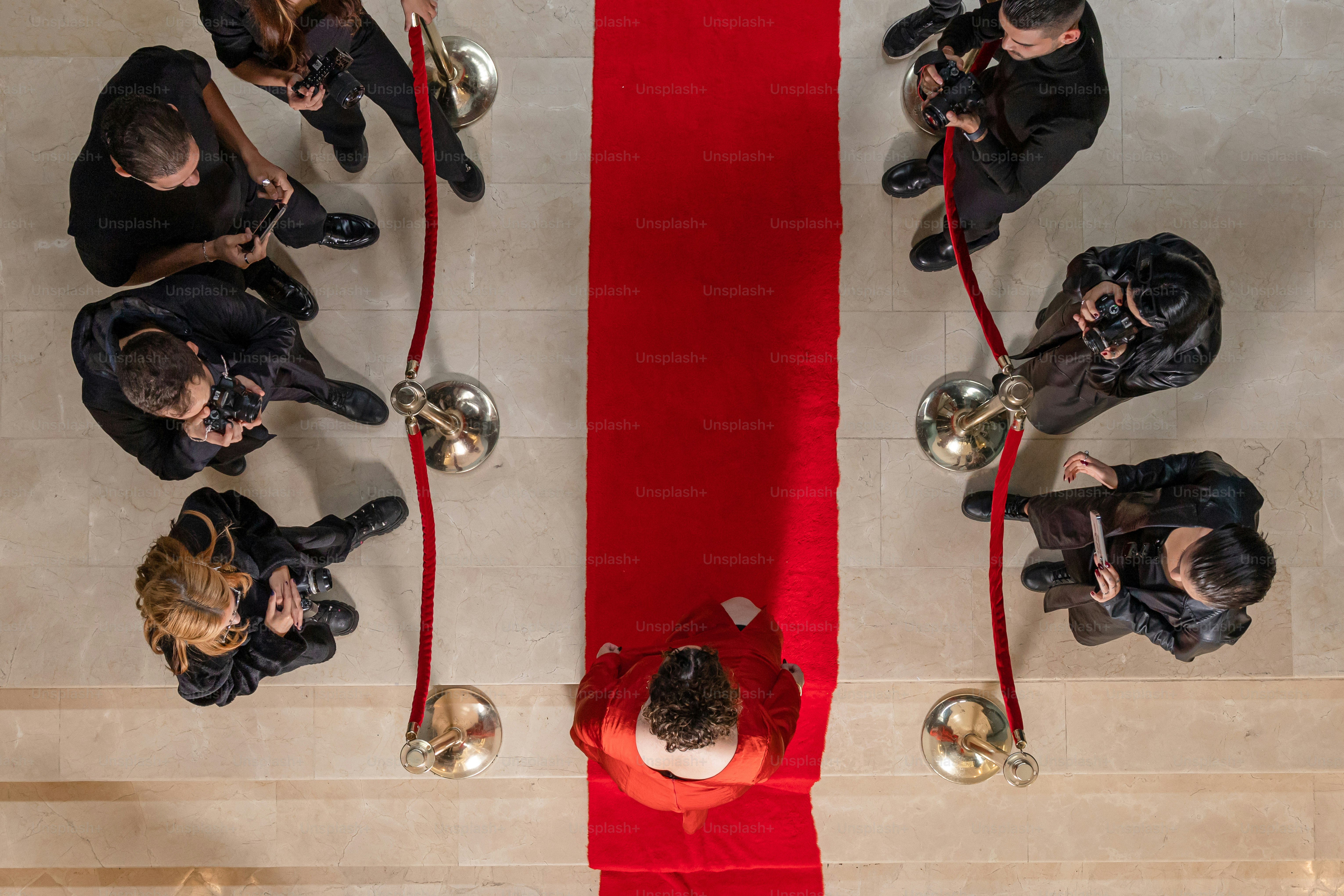 A group of people standing in front of a red ribbon