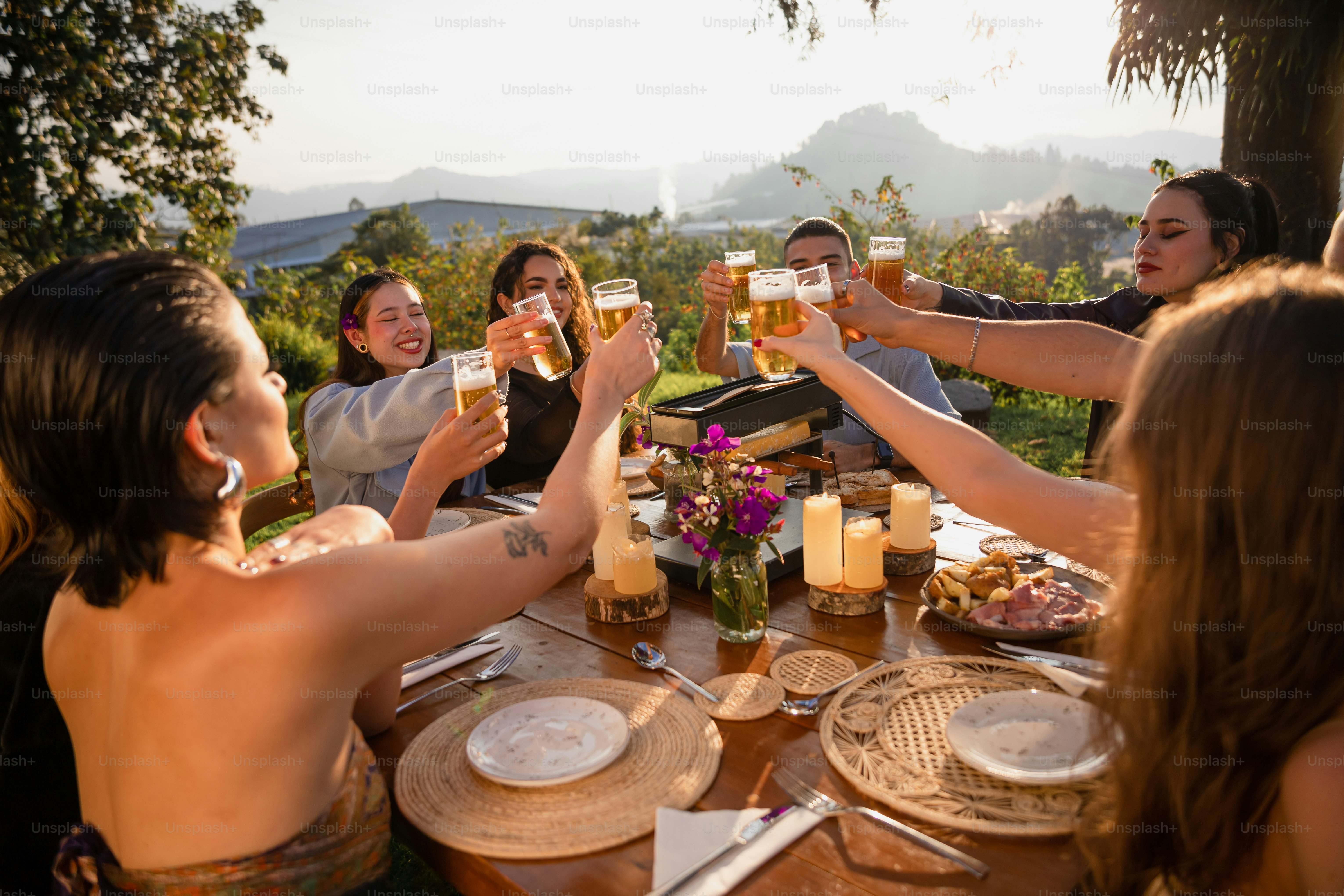 A group of people sitting around a table drinking beer