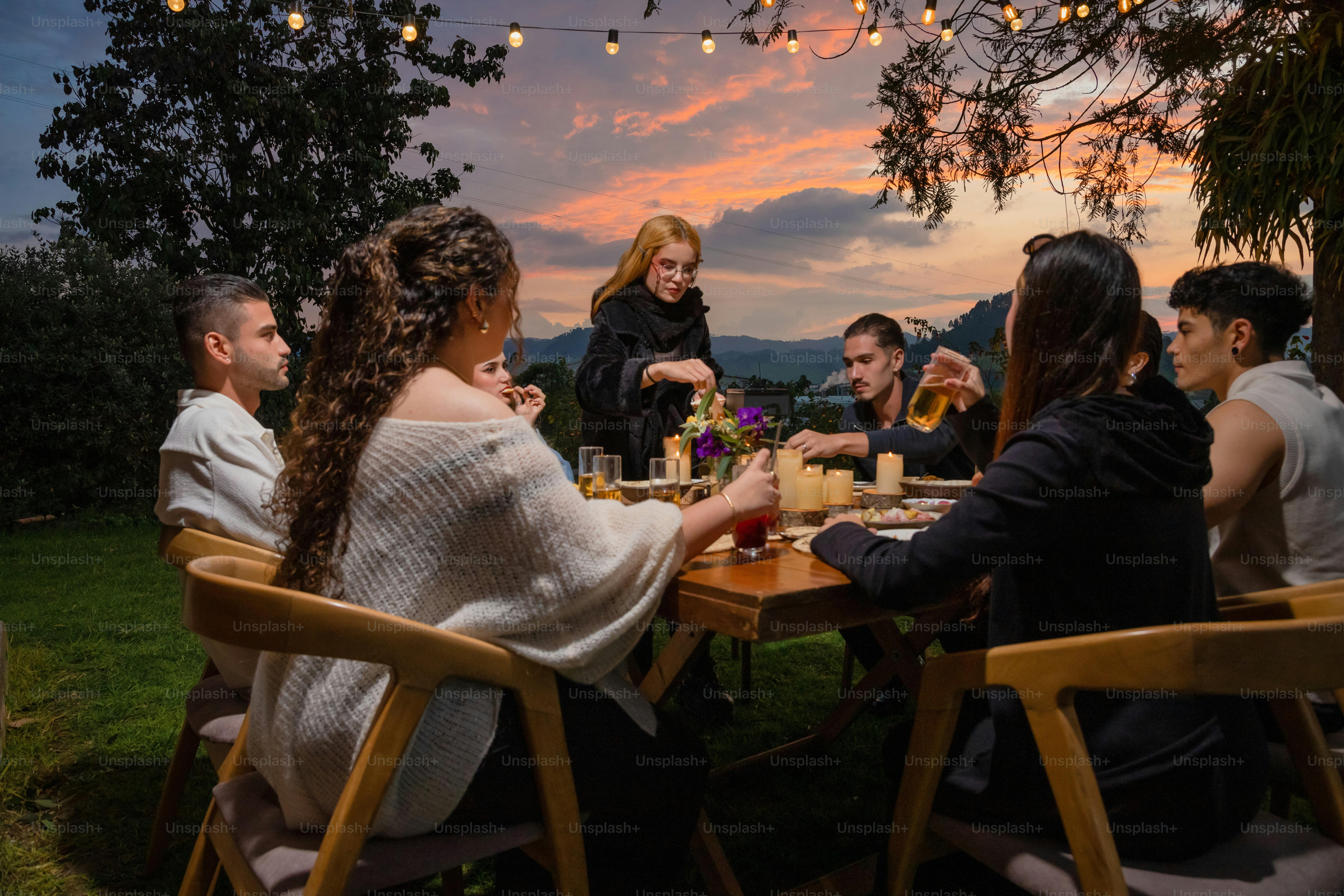 A group of people sitting around a wooden table