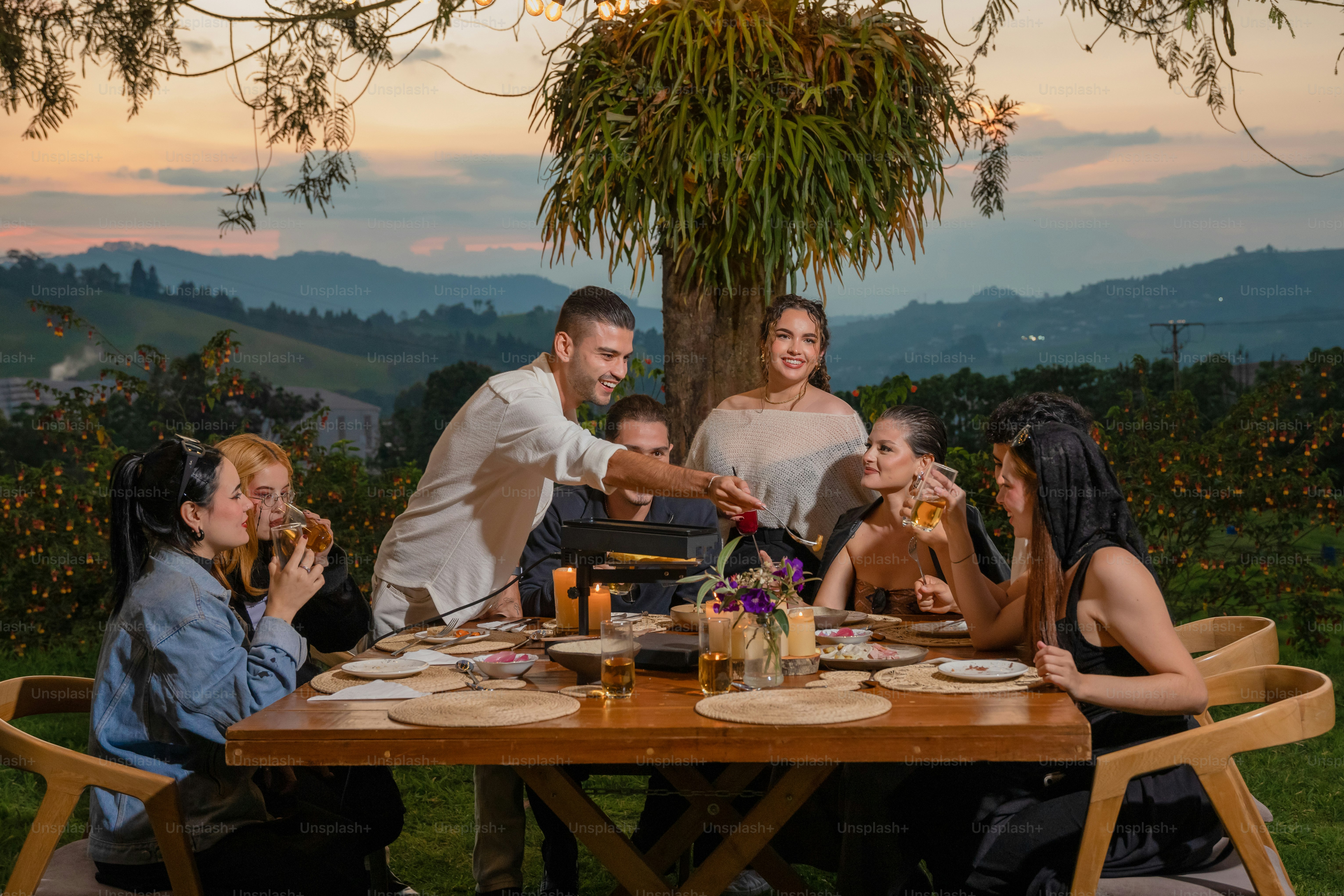 A group of people sitting around a wooden table