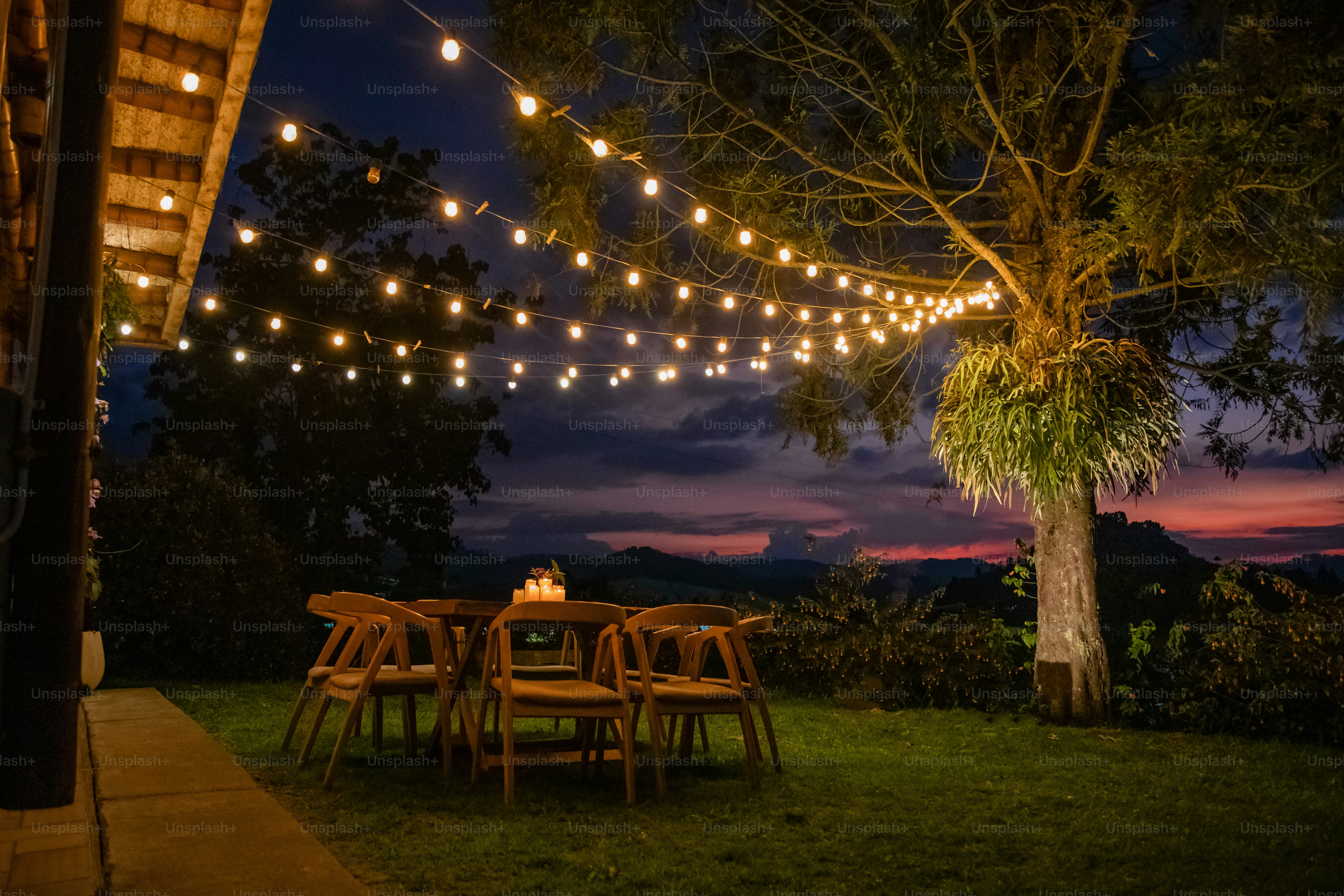 A patio with a string of lights strung over it