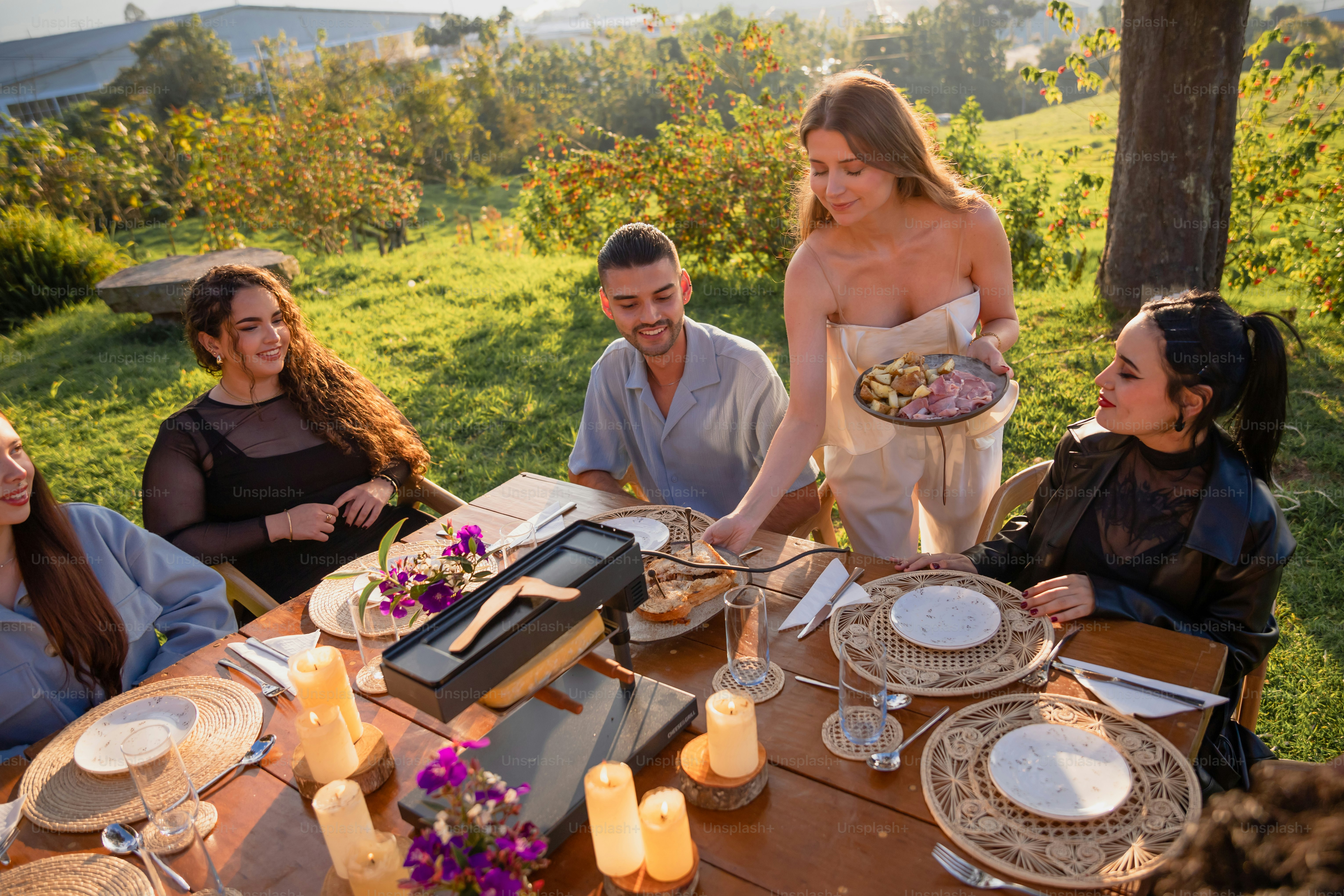 A group of people sitting around a wooden table