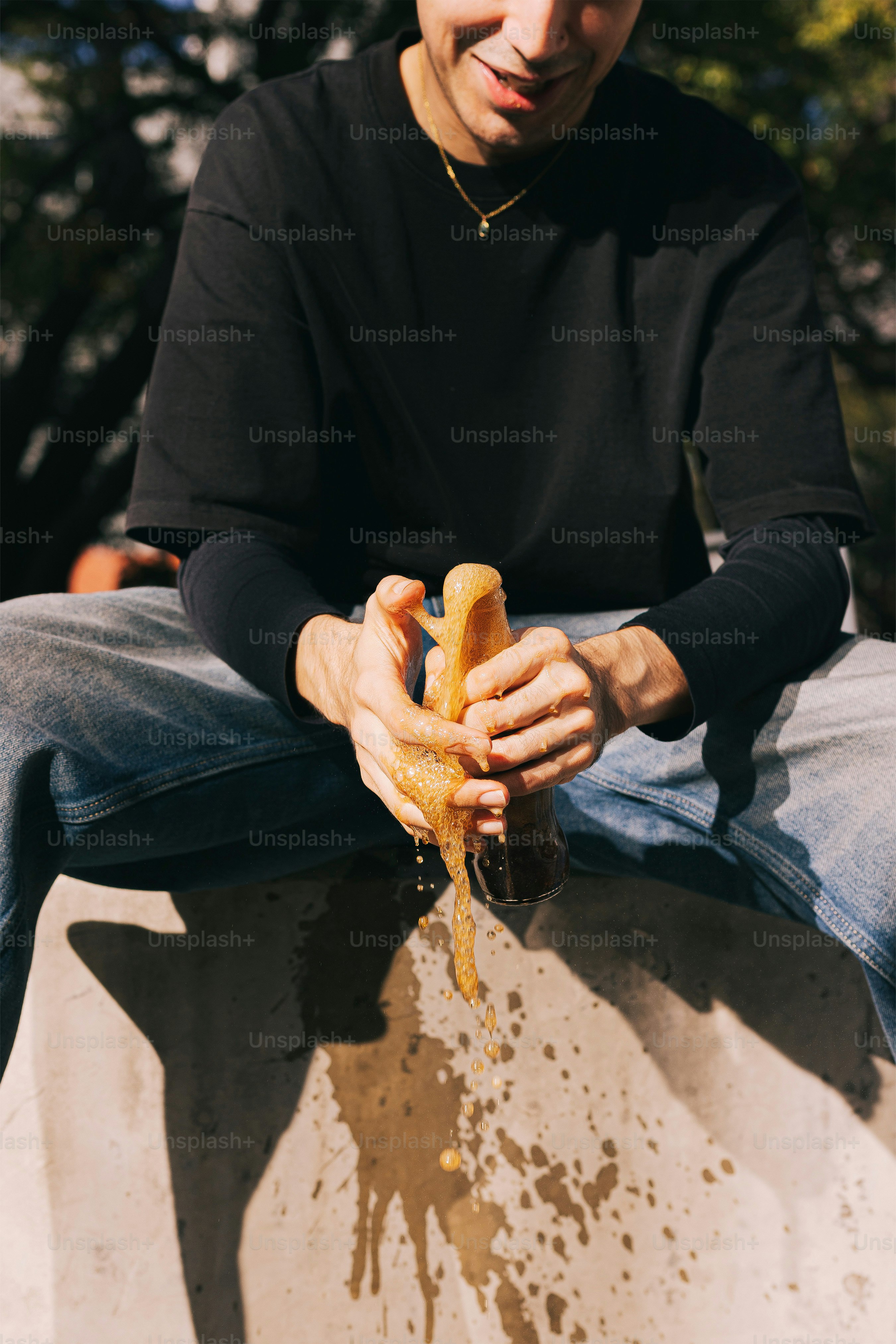 A man sitting on top of a cement structure