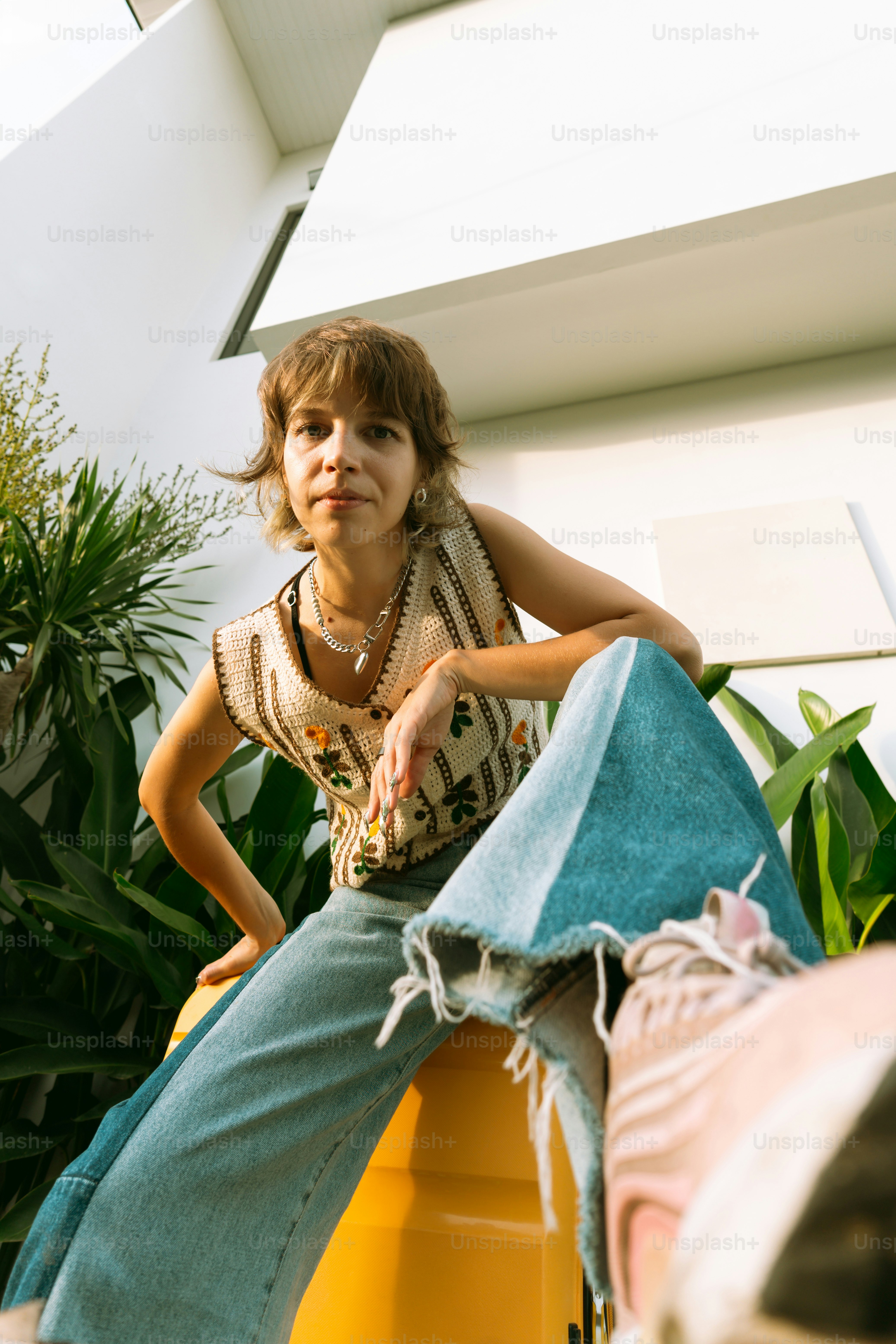 A woman sitting on top of a yellow object