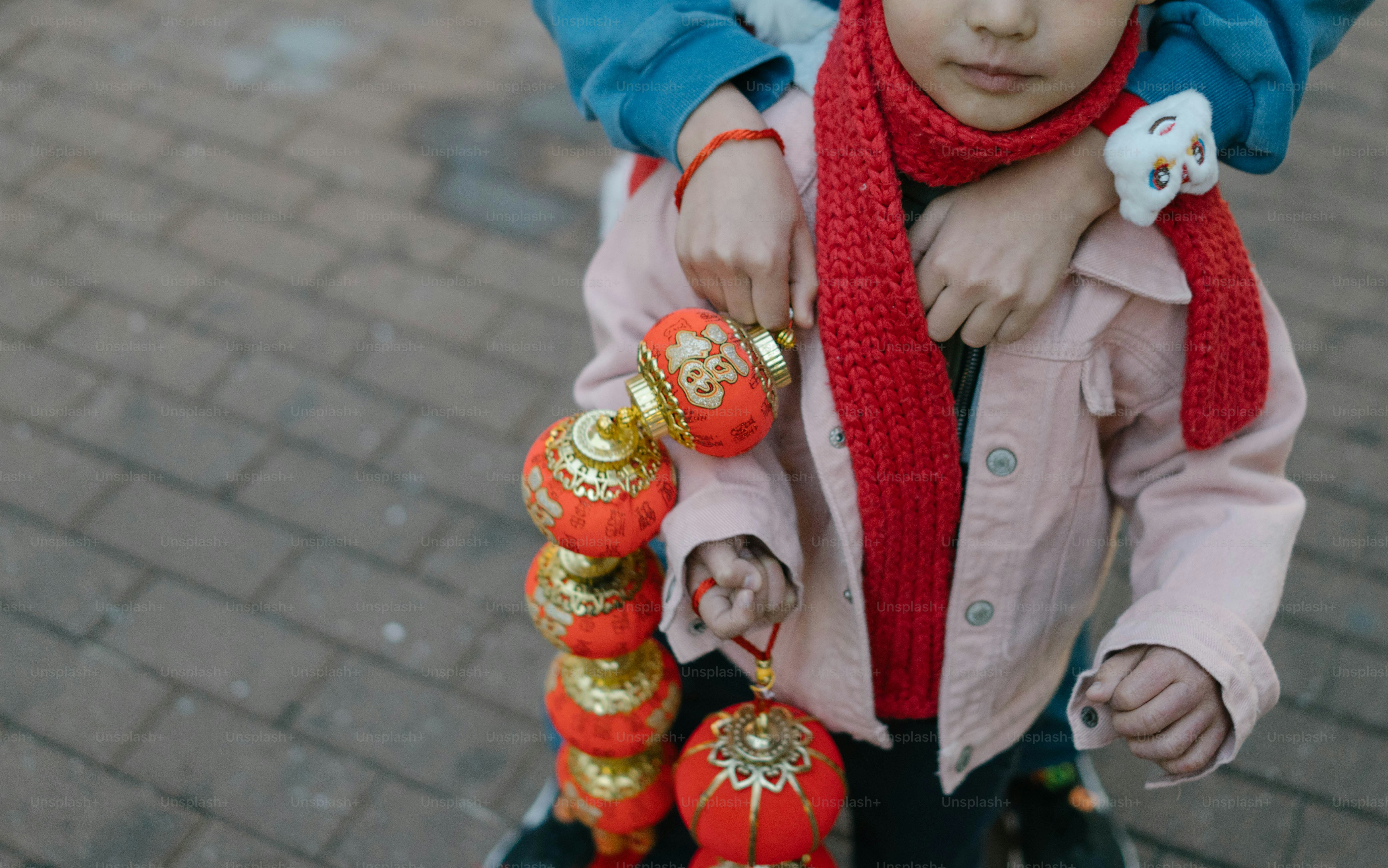 A little girl riding on the back of a scooter