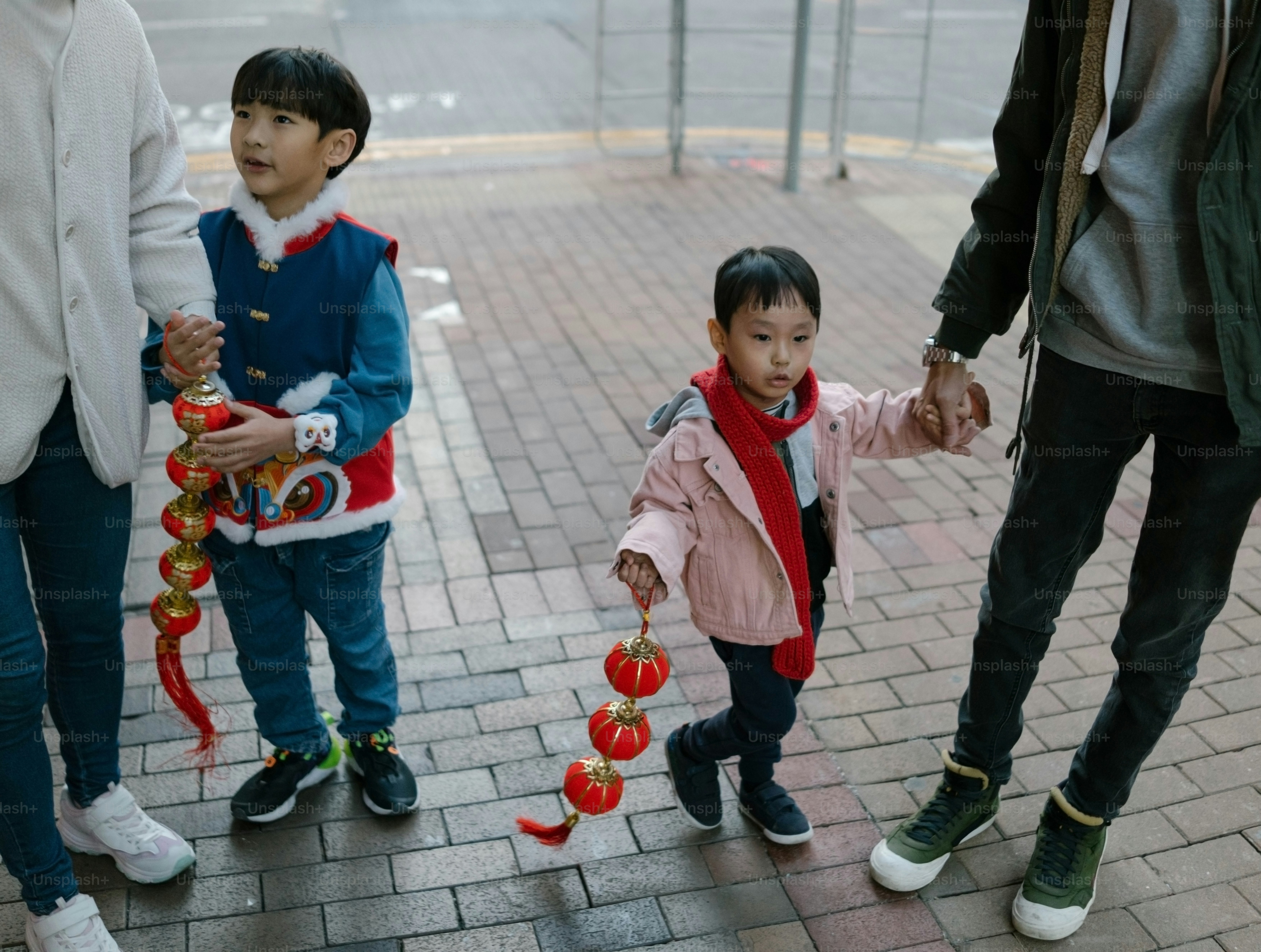 A group of people standing next to each other on a sidewalk