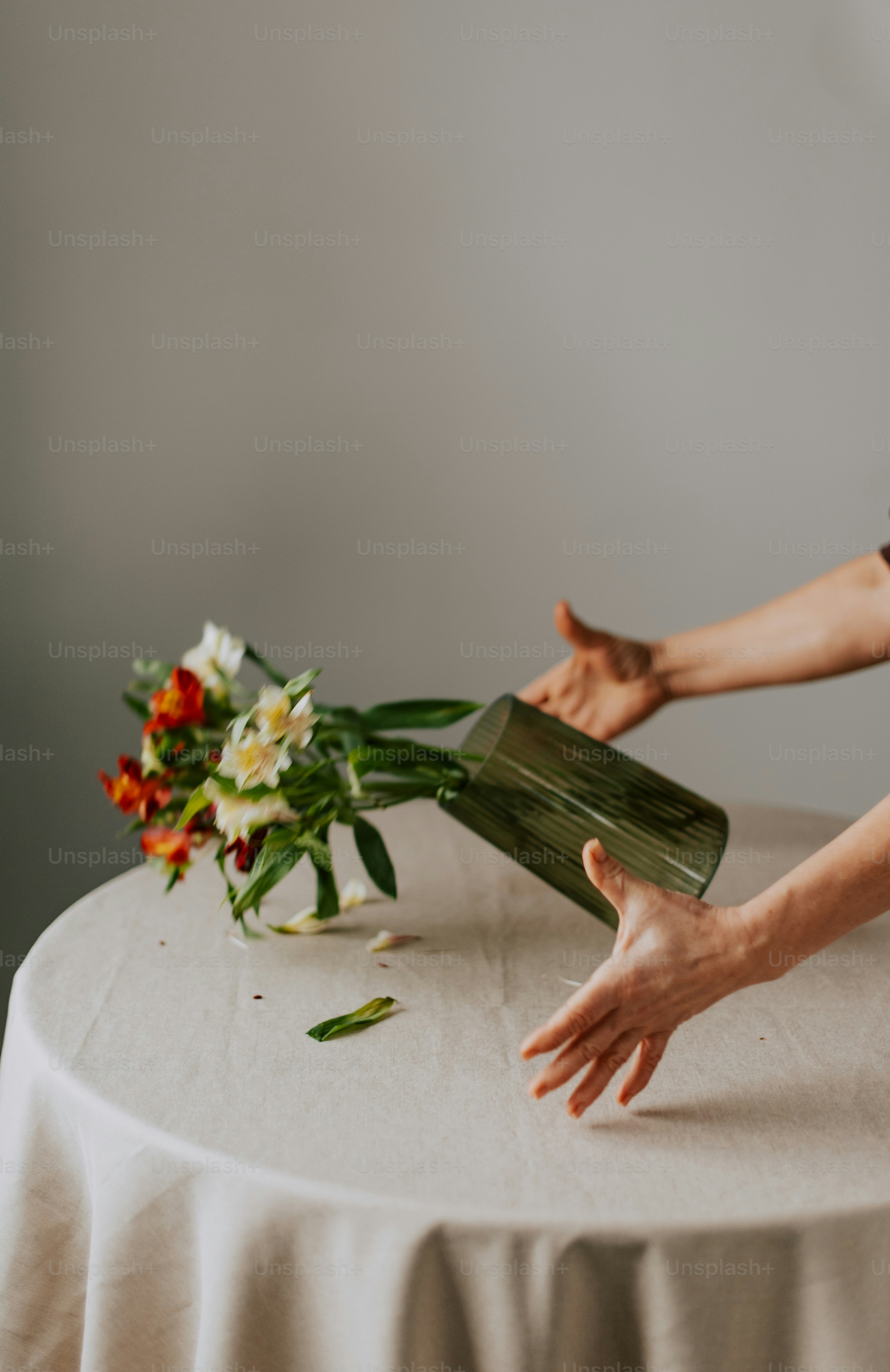 A woman arranging flowers on a table