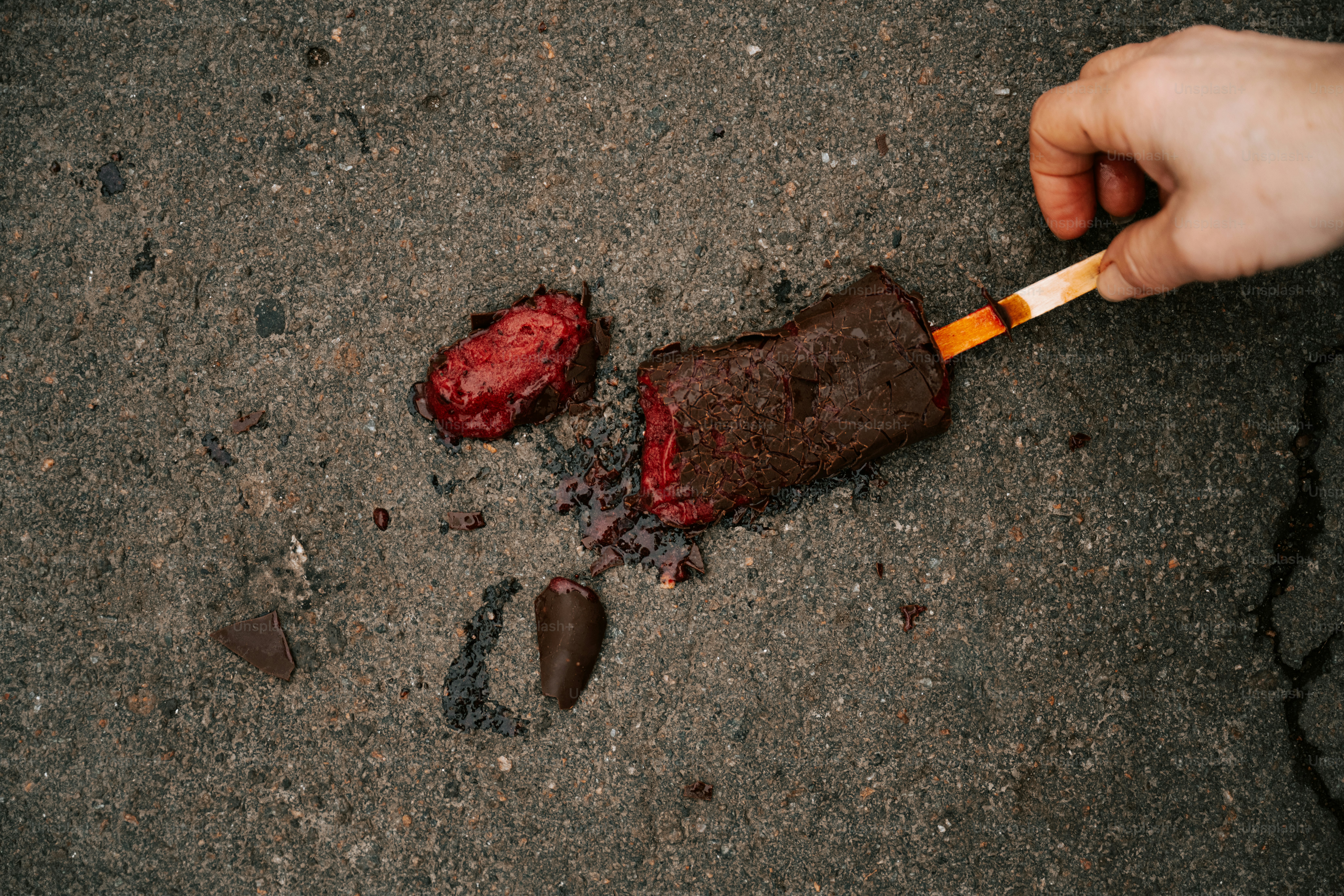 Une personne tient une cigarette et un morceau de chocolat