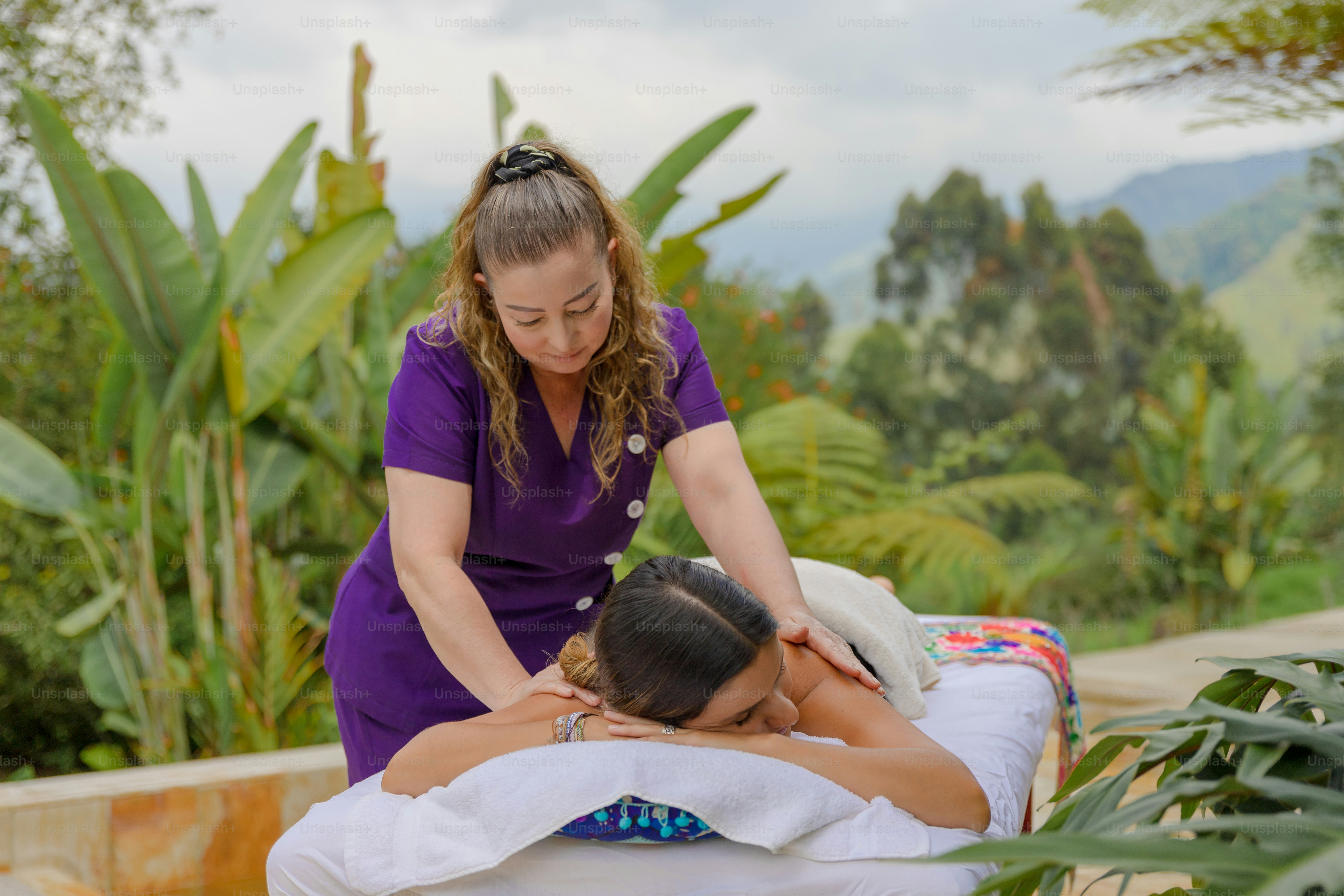 A woman getting a back massage from a man