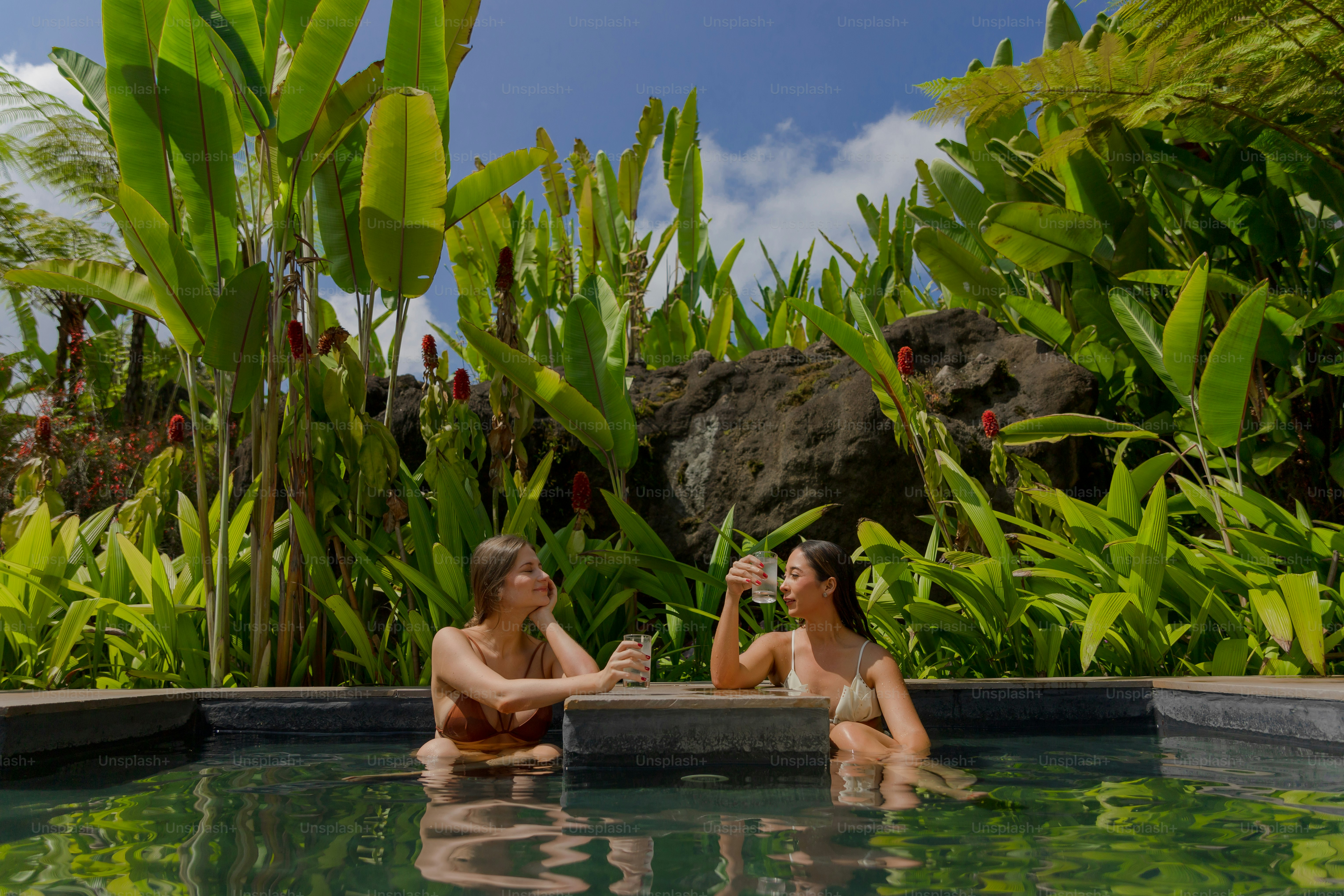 A couple of people that are sitting in a pool