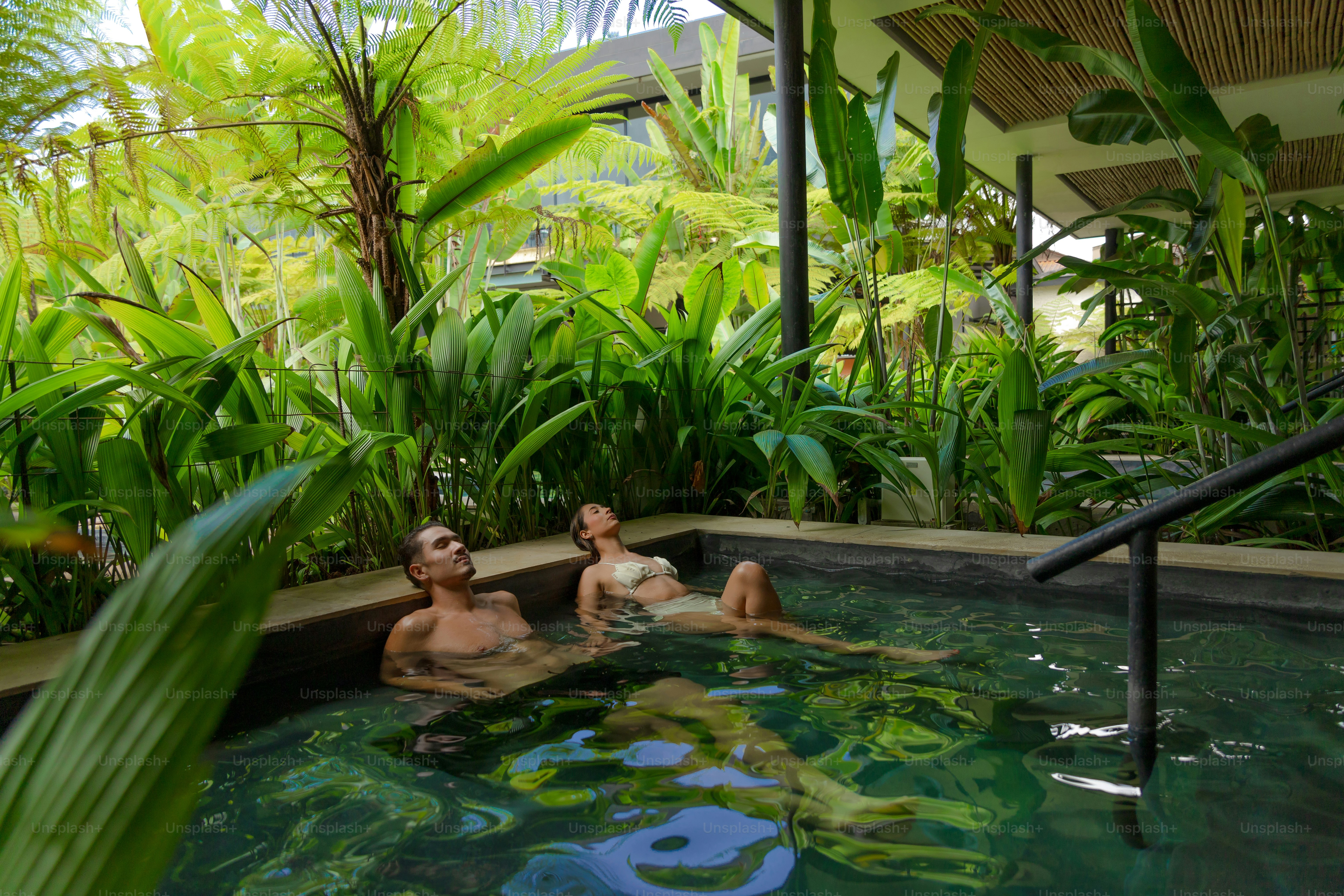 A couple of people that are in a pool