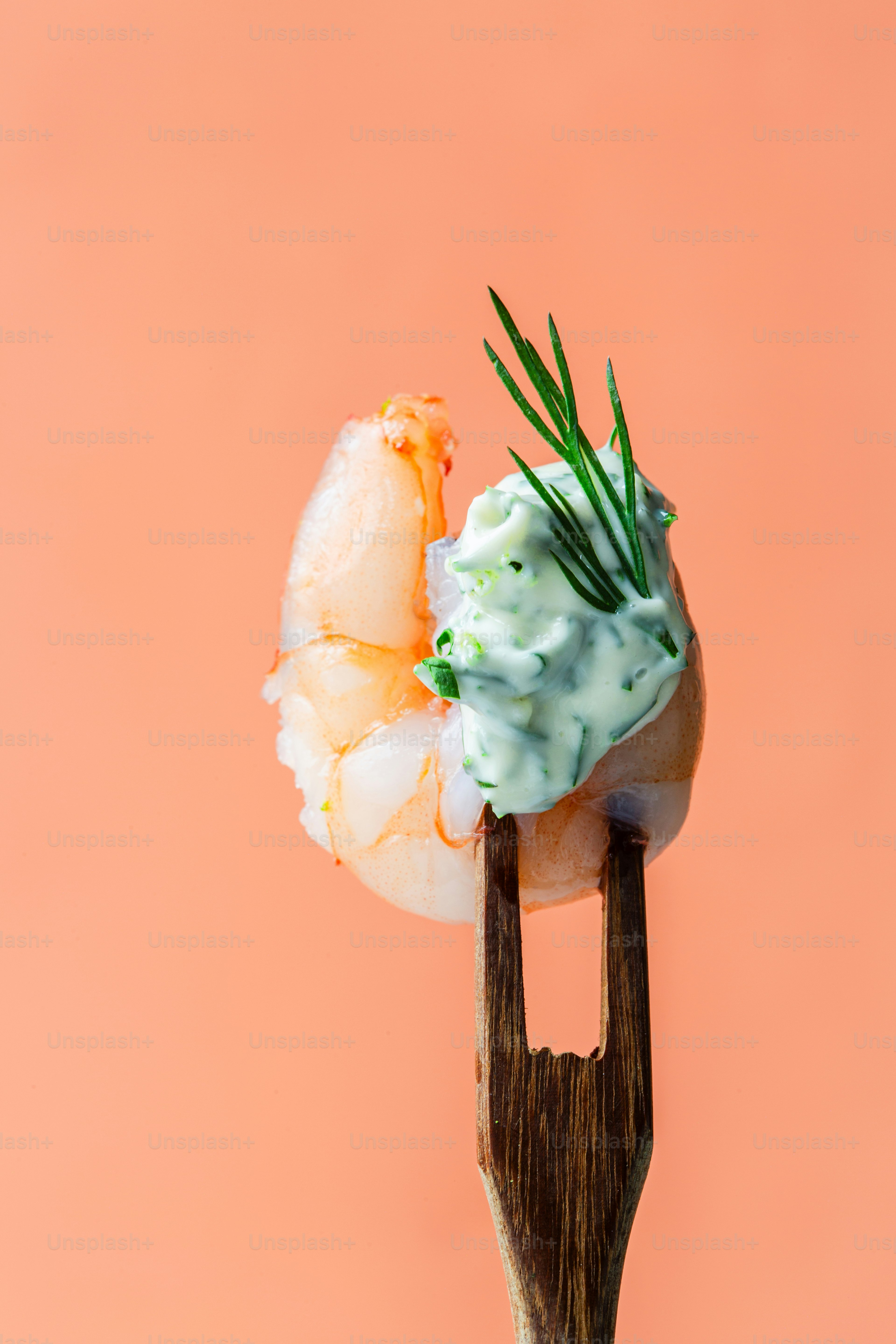 A wooden fork with food on top of it