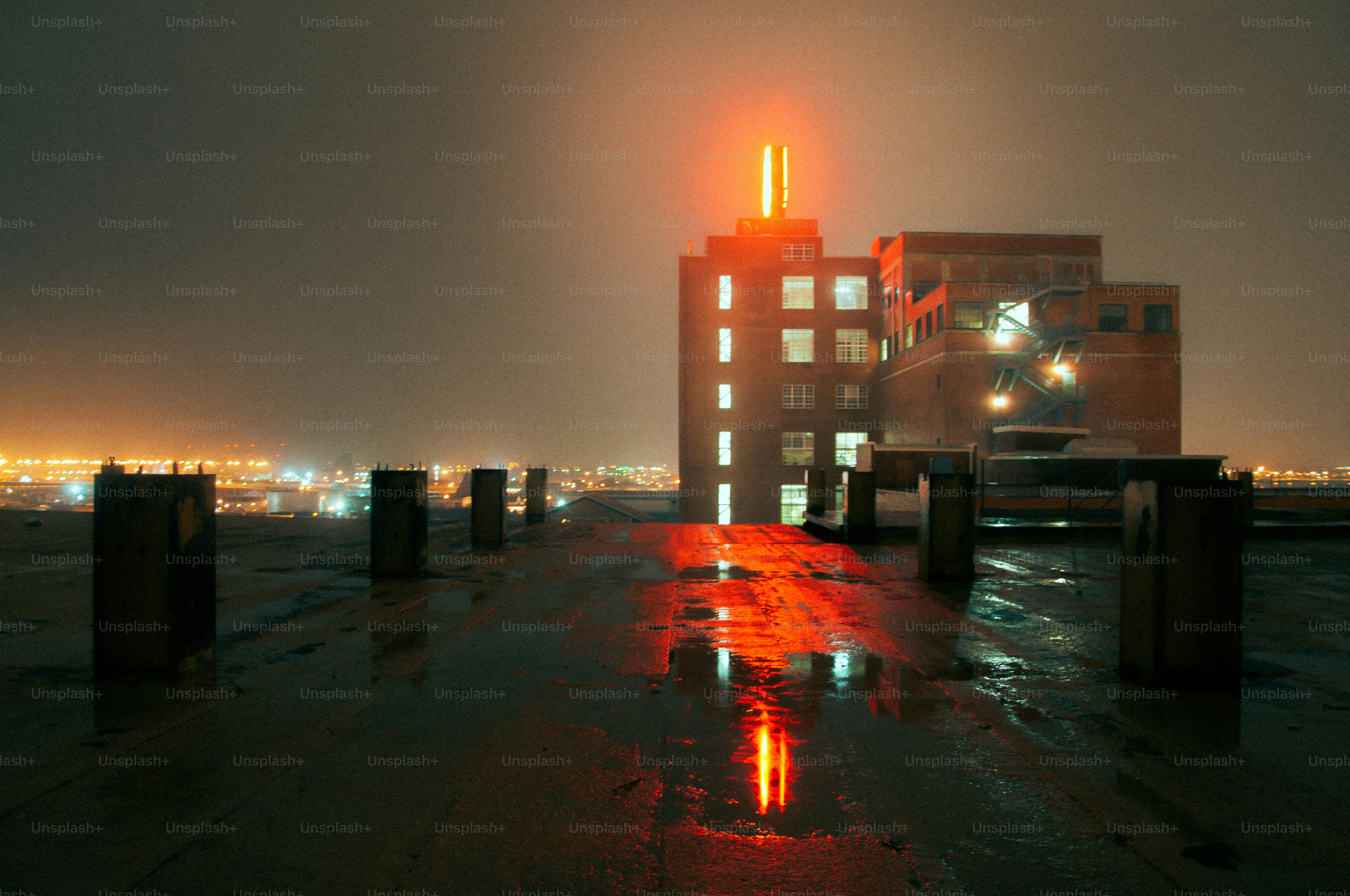 A view of a city at night from the top of a building photo – City Image ...