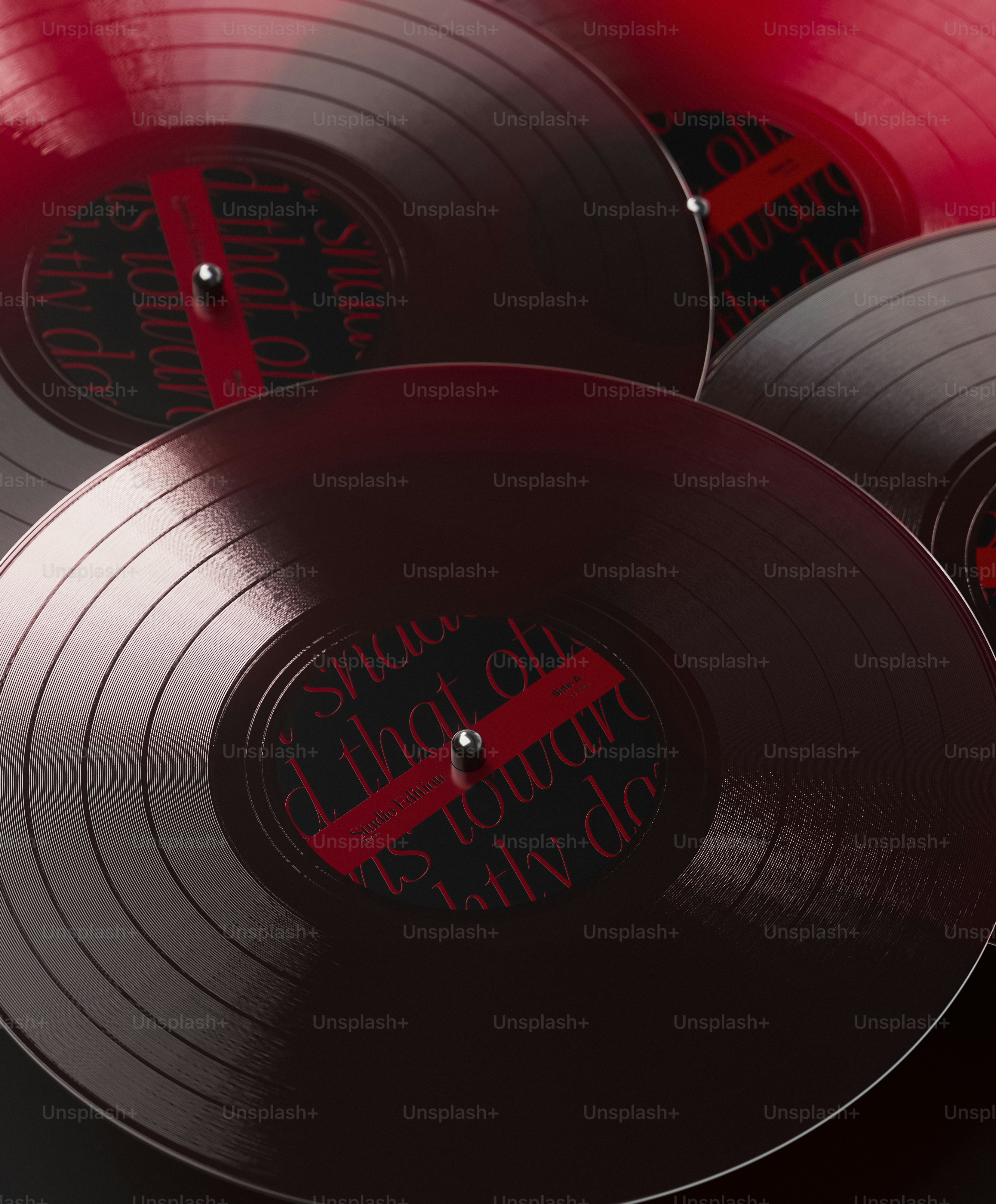 A group of red and black records sitting on top of each other