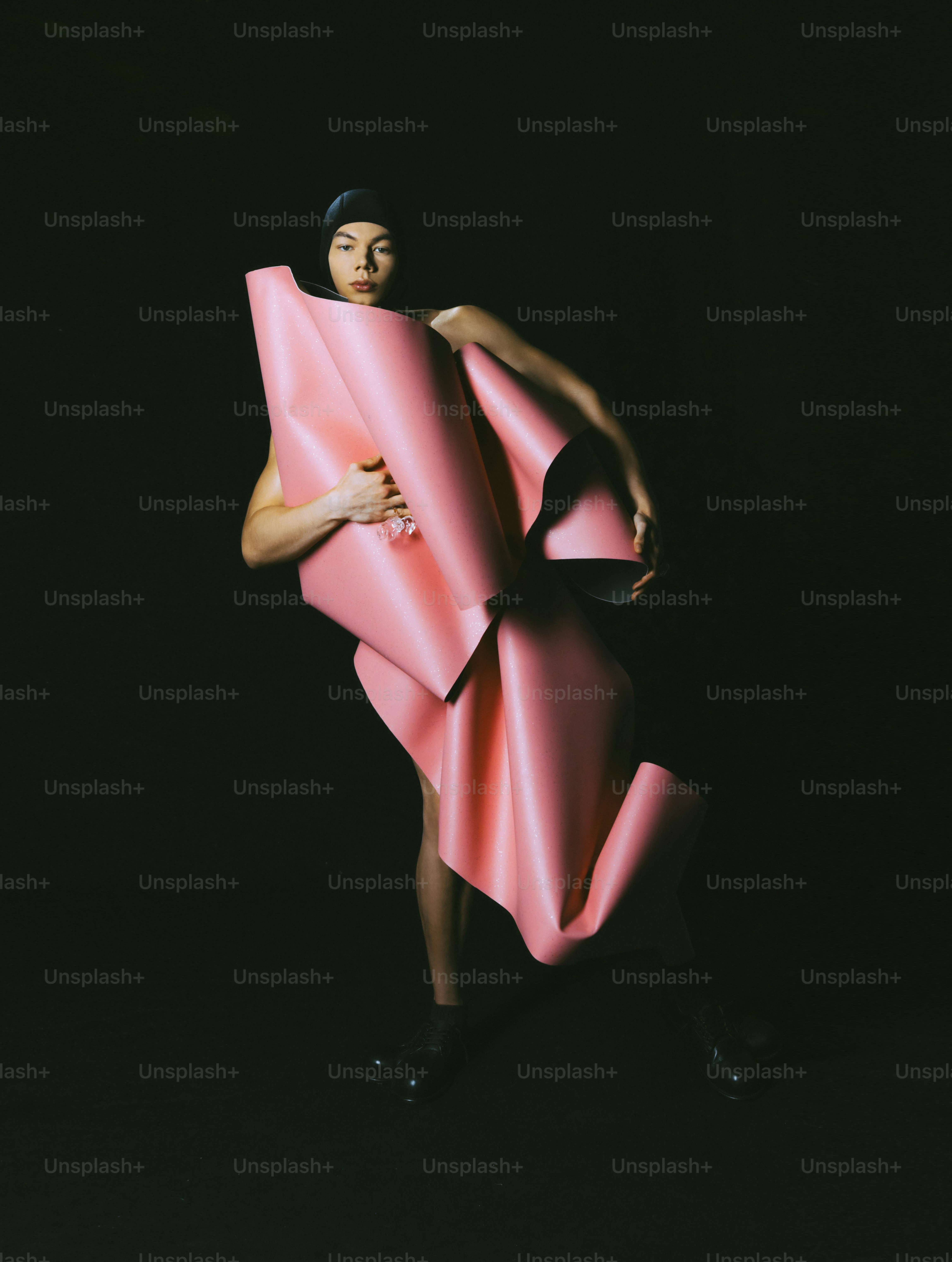 A woman in a pink dress holding a pink object