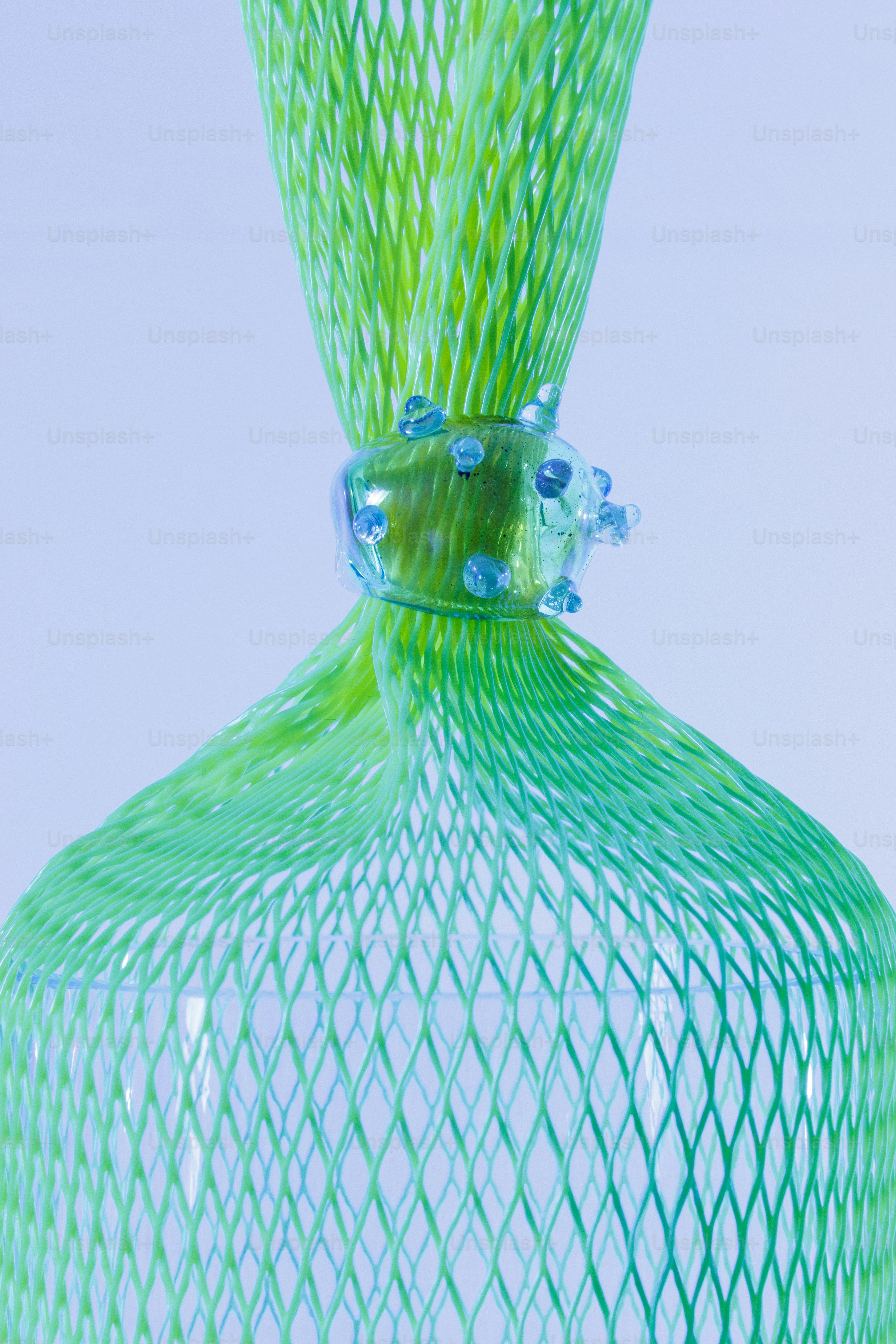 A green glass vase sitting on top of a table