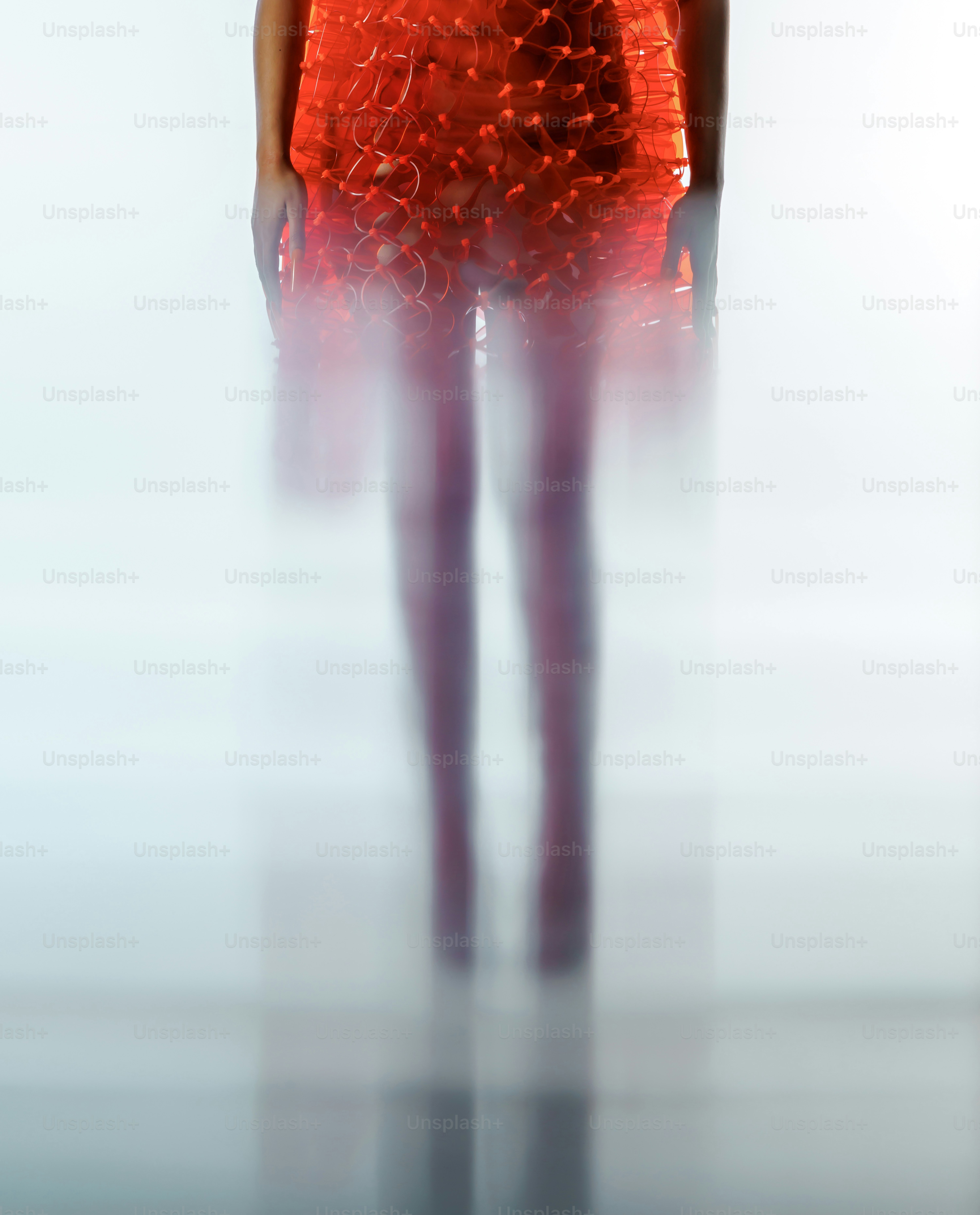 A woman in a red dress standing in a room