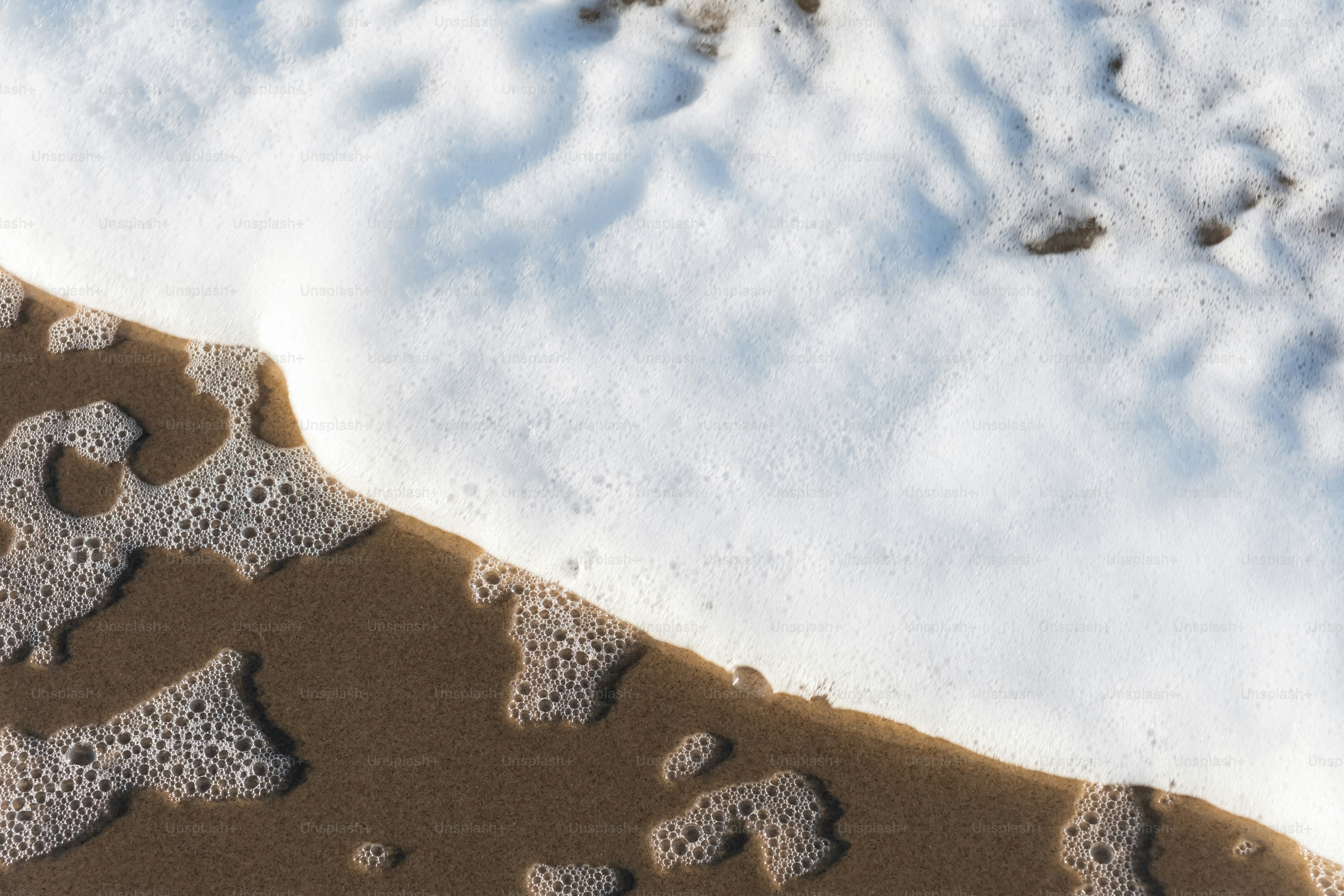 A sandy beach covered in lots of snow