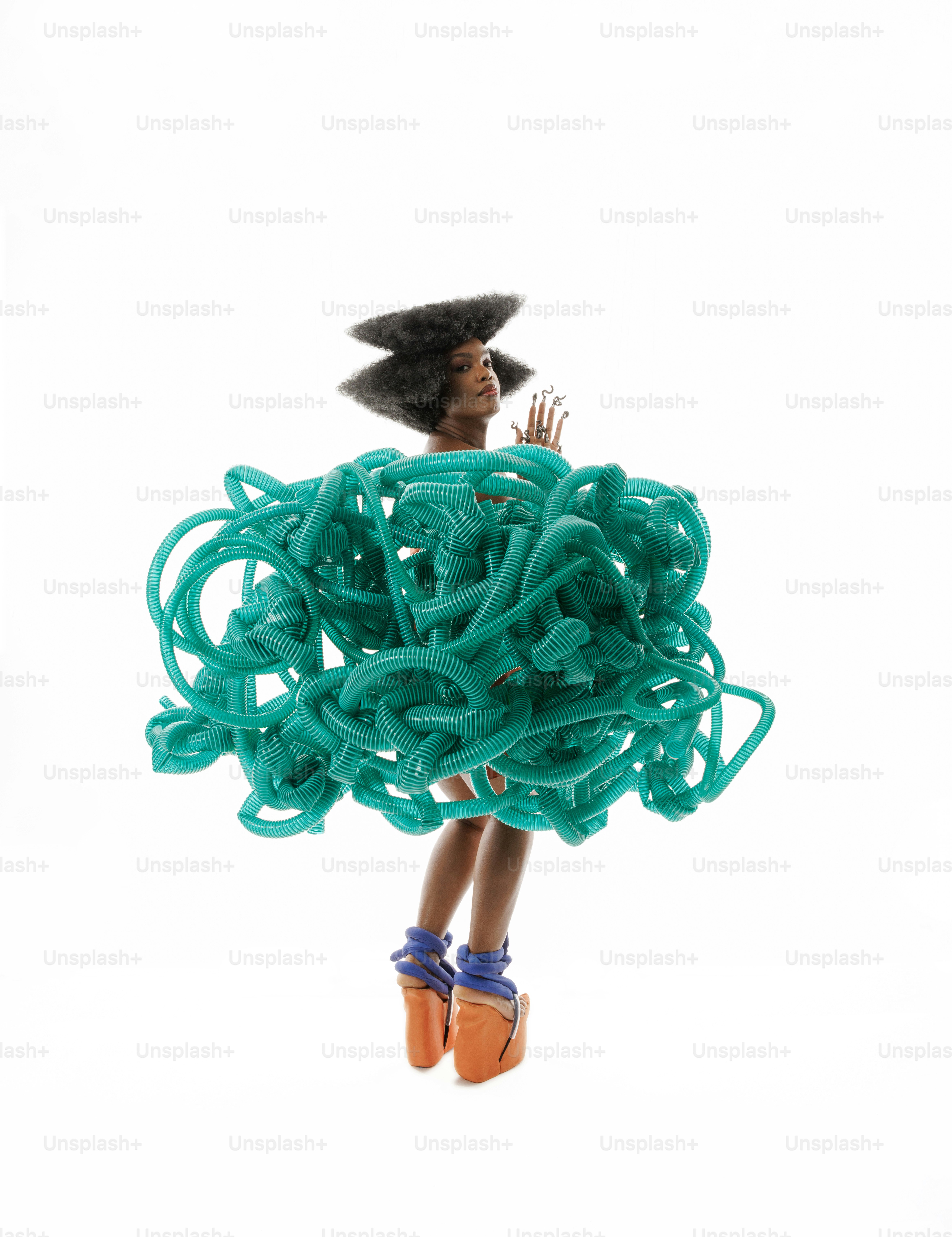 A woman in a dress made out of green cords