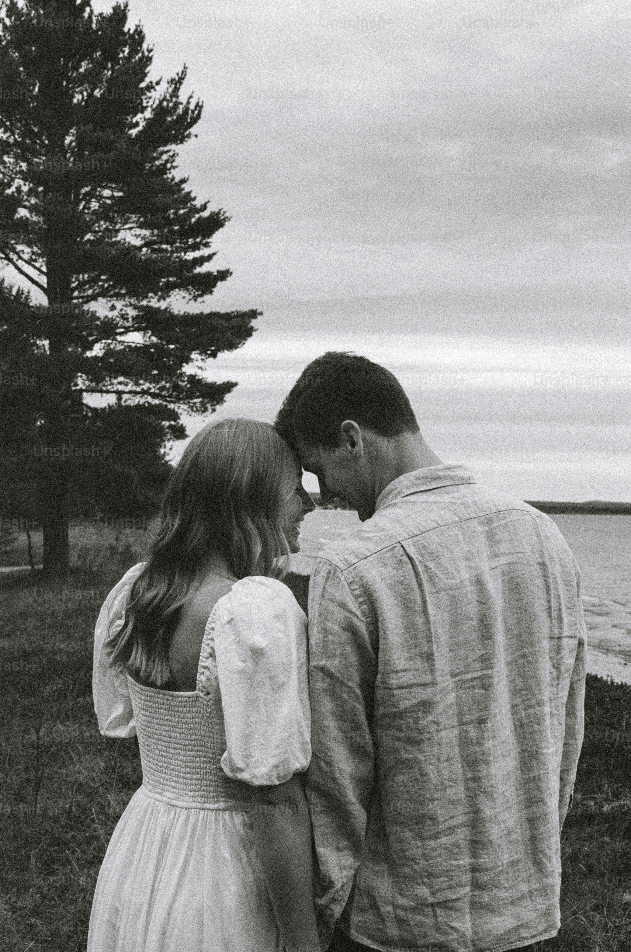 Couple shares an intimate moment outdoors in nature.