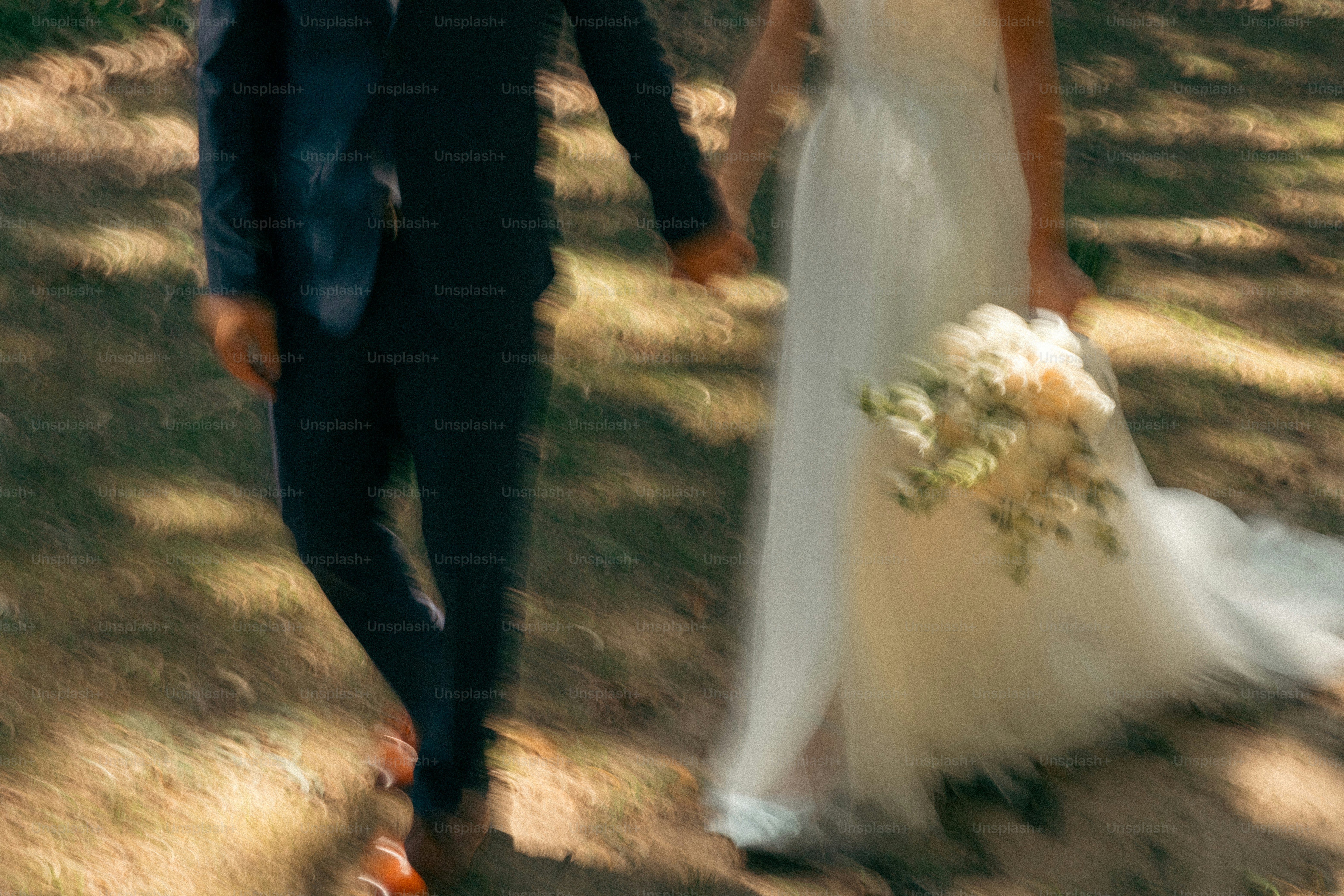 A bride and groom walking through the woods