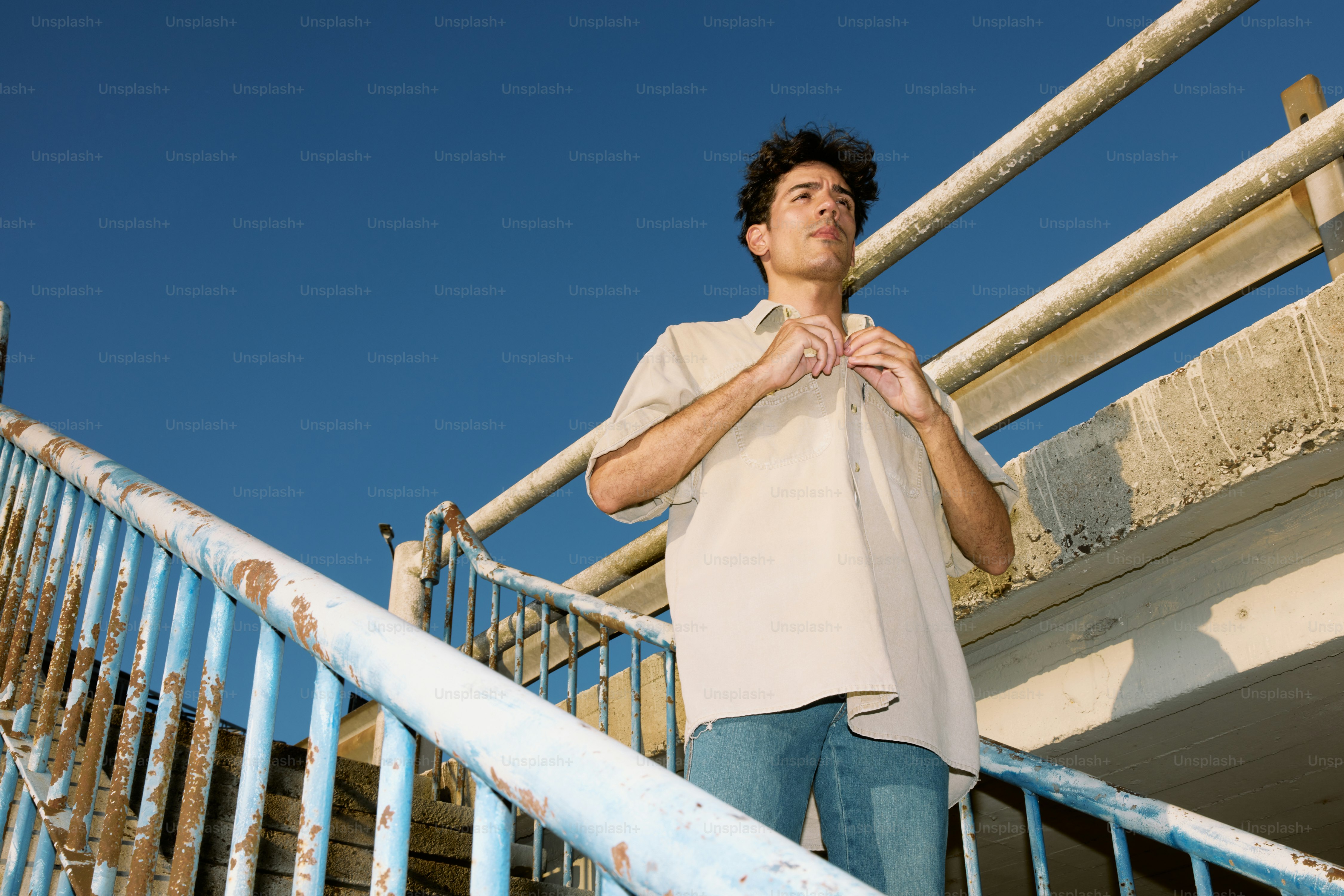 A man standing on a stair case next to a railing