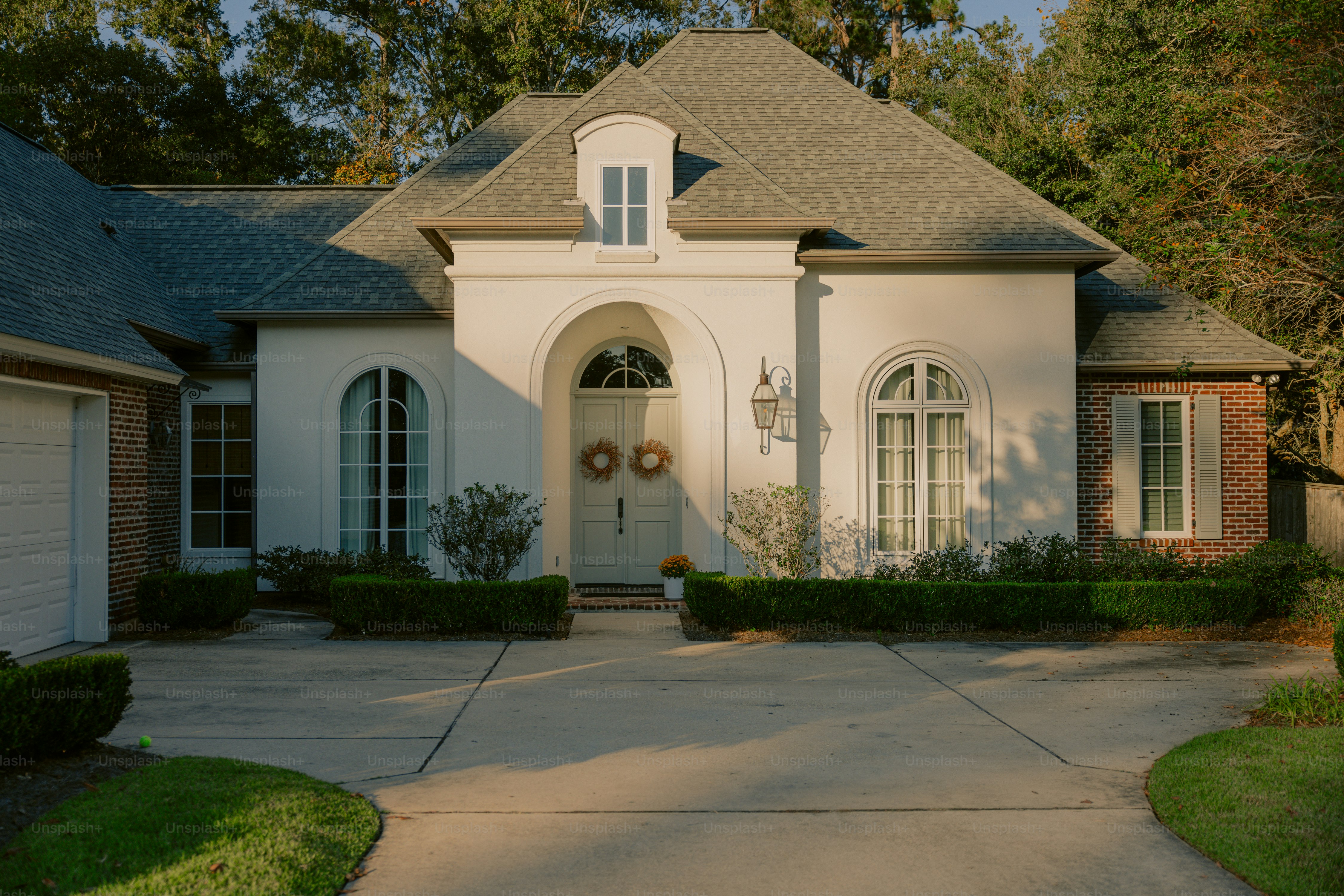 A large white house with a large driveway