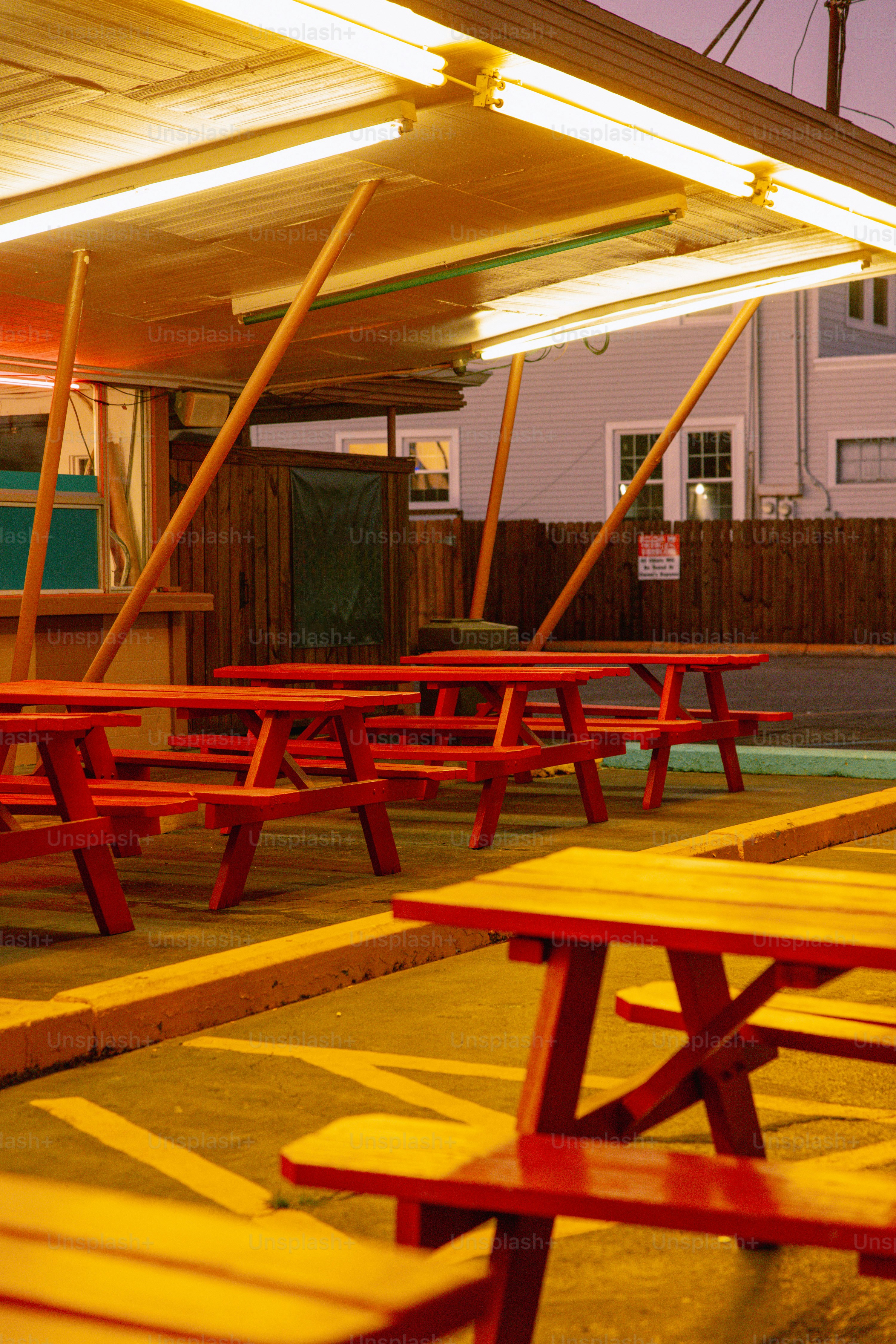 A row of red and yellow benches sitting next to each other