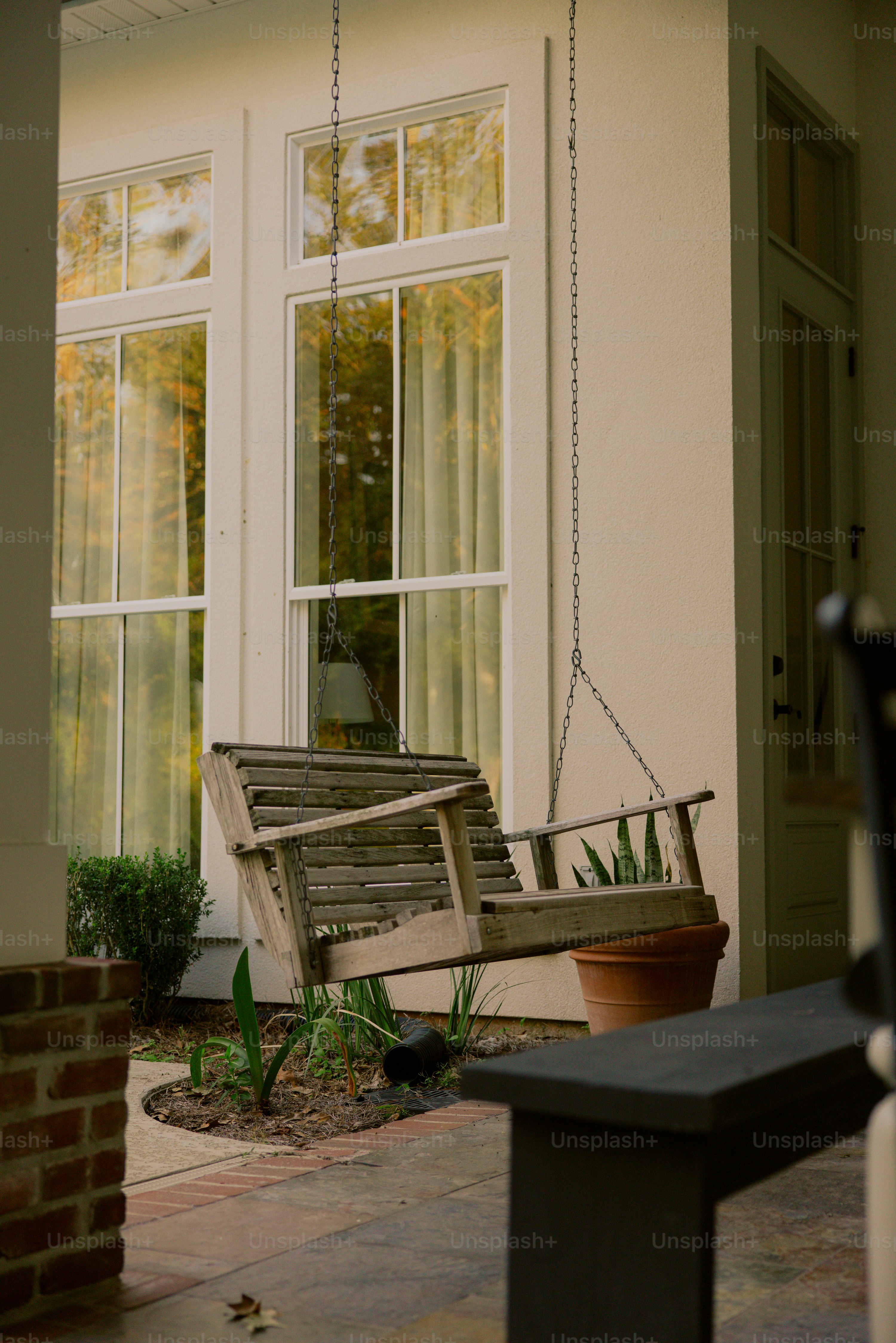 A wooden bench sitting in front of a window