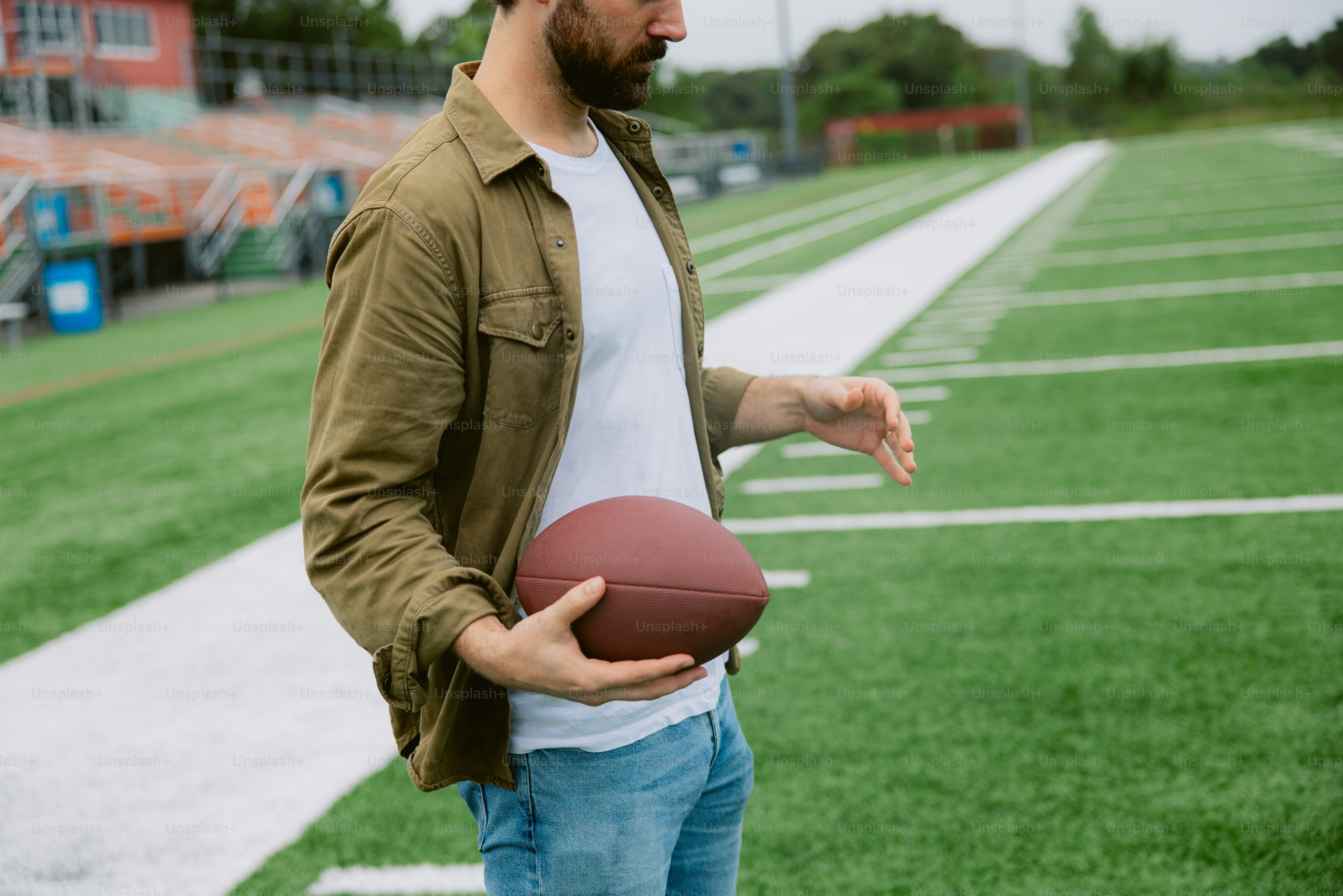 A man holding a football on a field