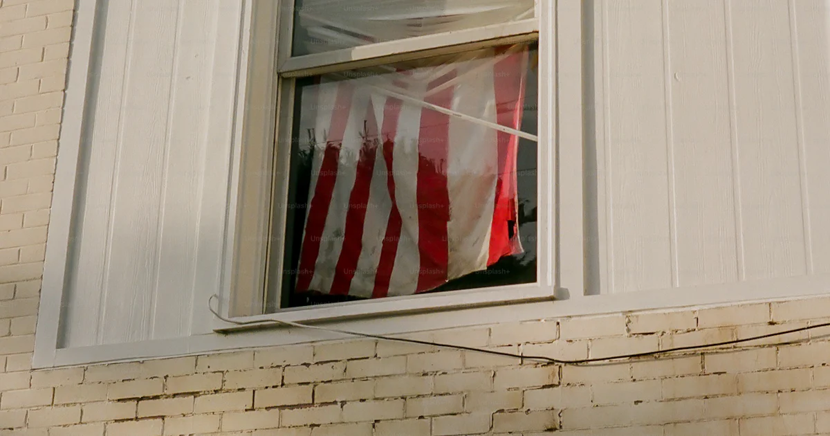 Flag In Window An american flag hanging in a window of a building photo – American ...