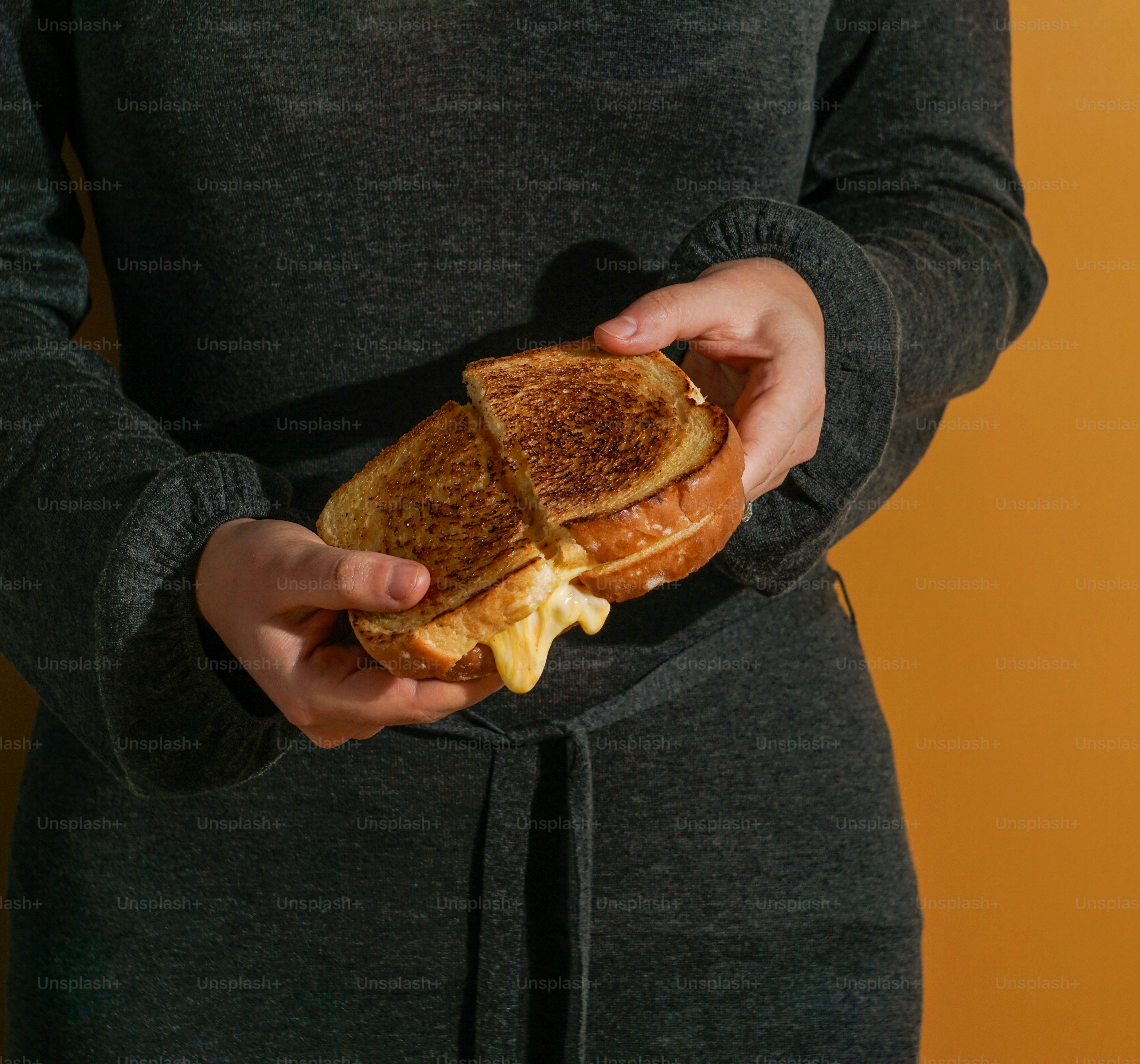 A woman holding a sandwich in her hands