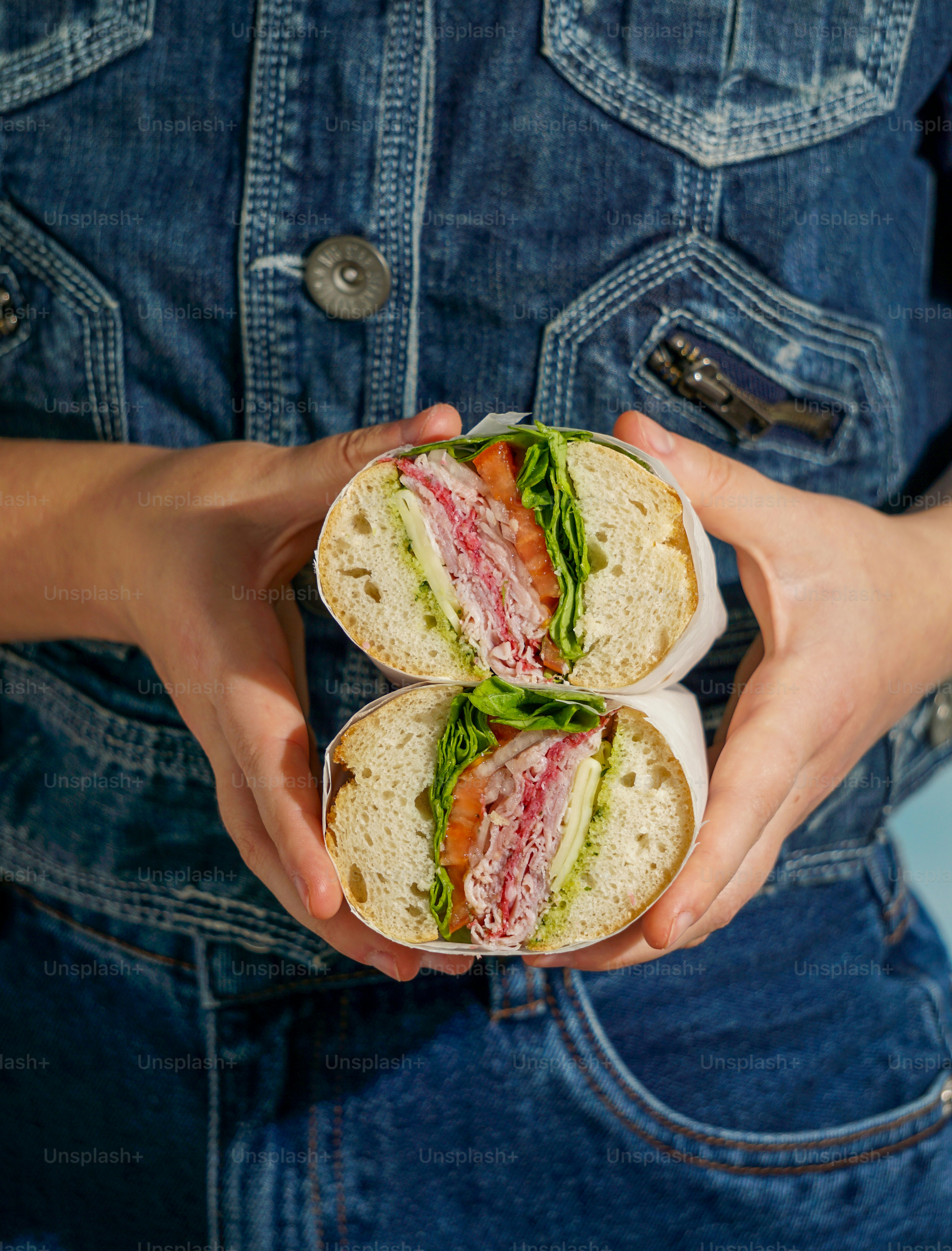 A person holding a sandwich in their hands