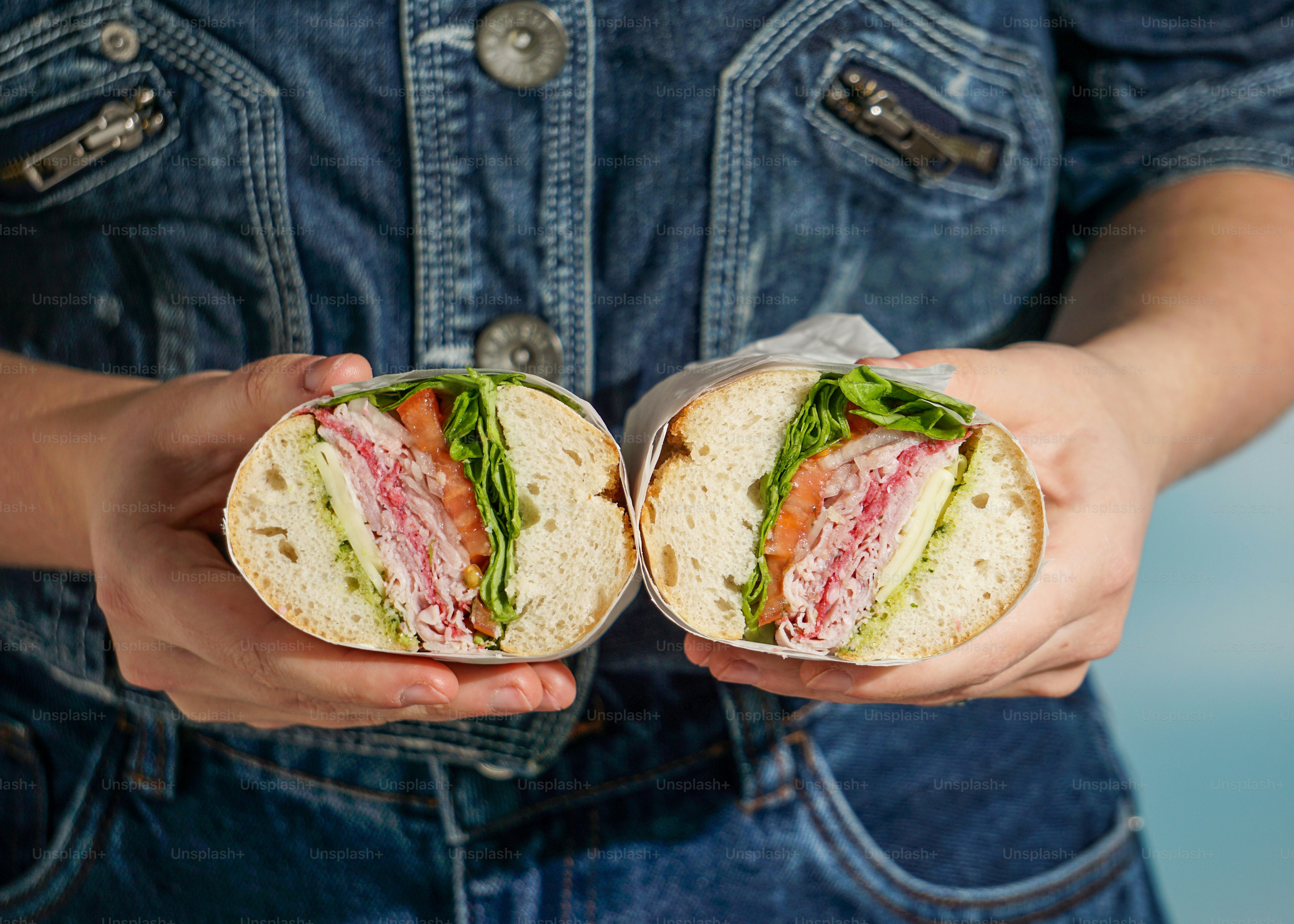 A person holding a sandwich in their hands