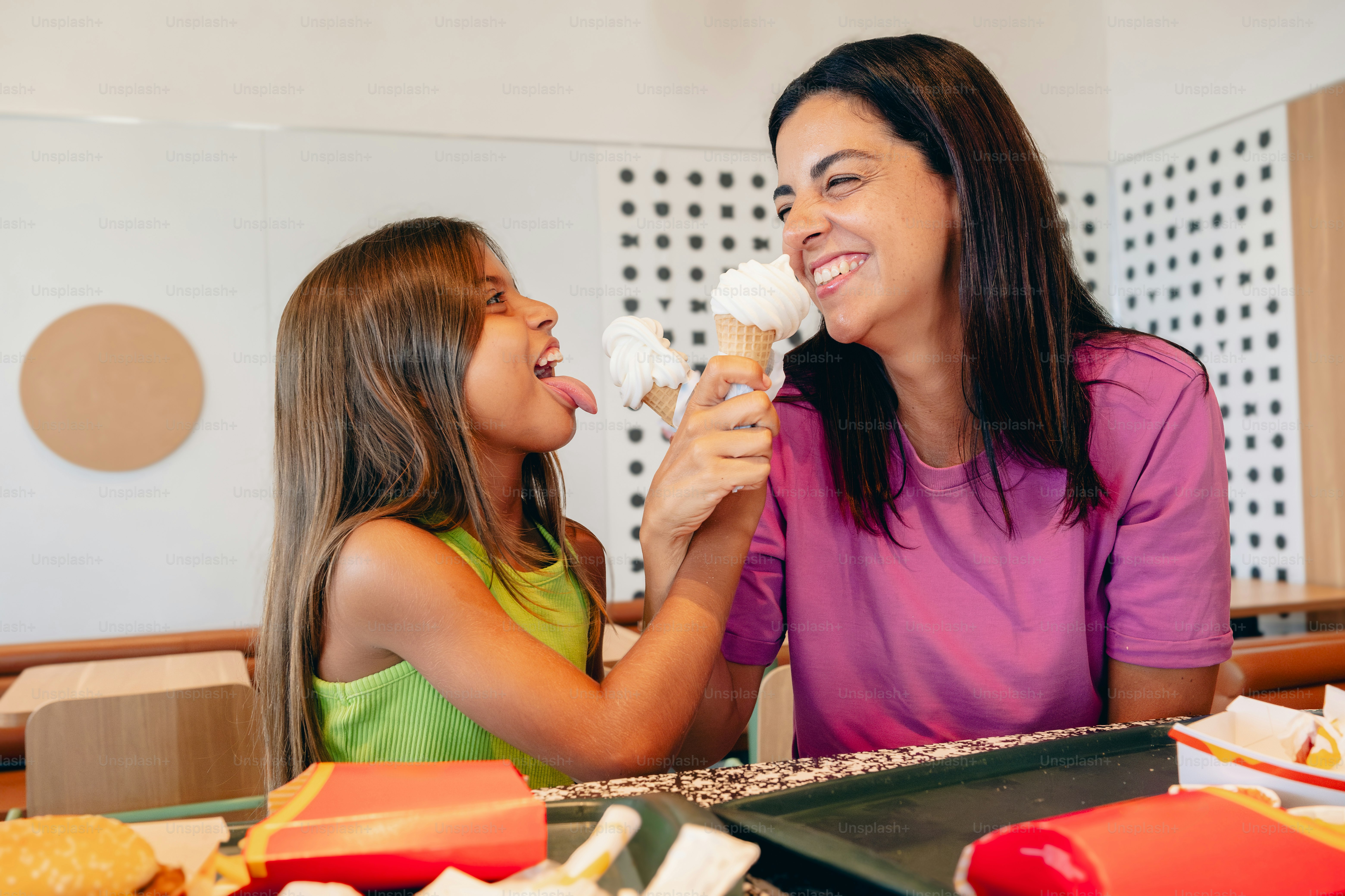 A woman and a little girl eating food together