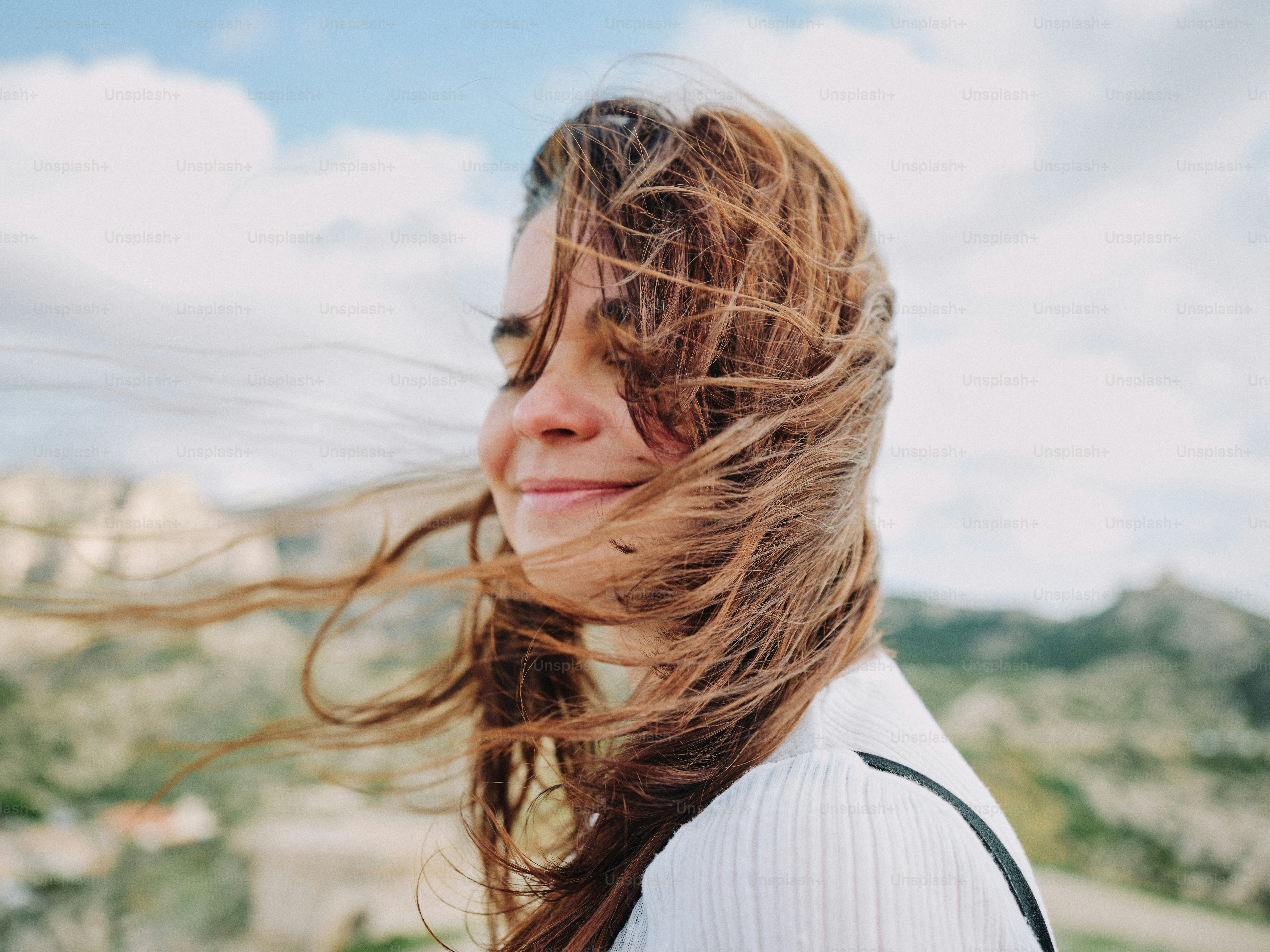 A woman enjoys the wind in her hair.