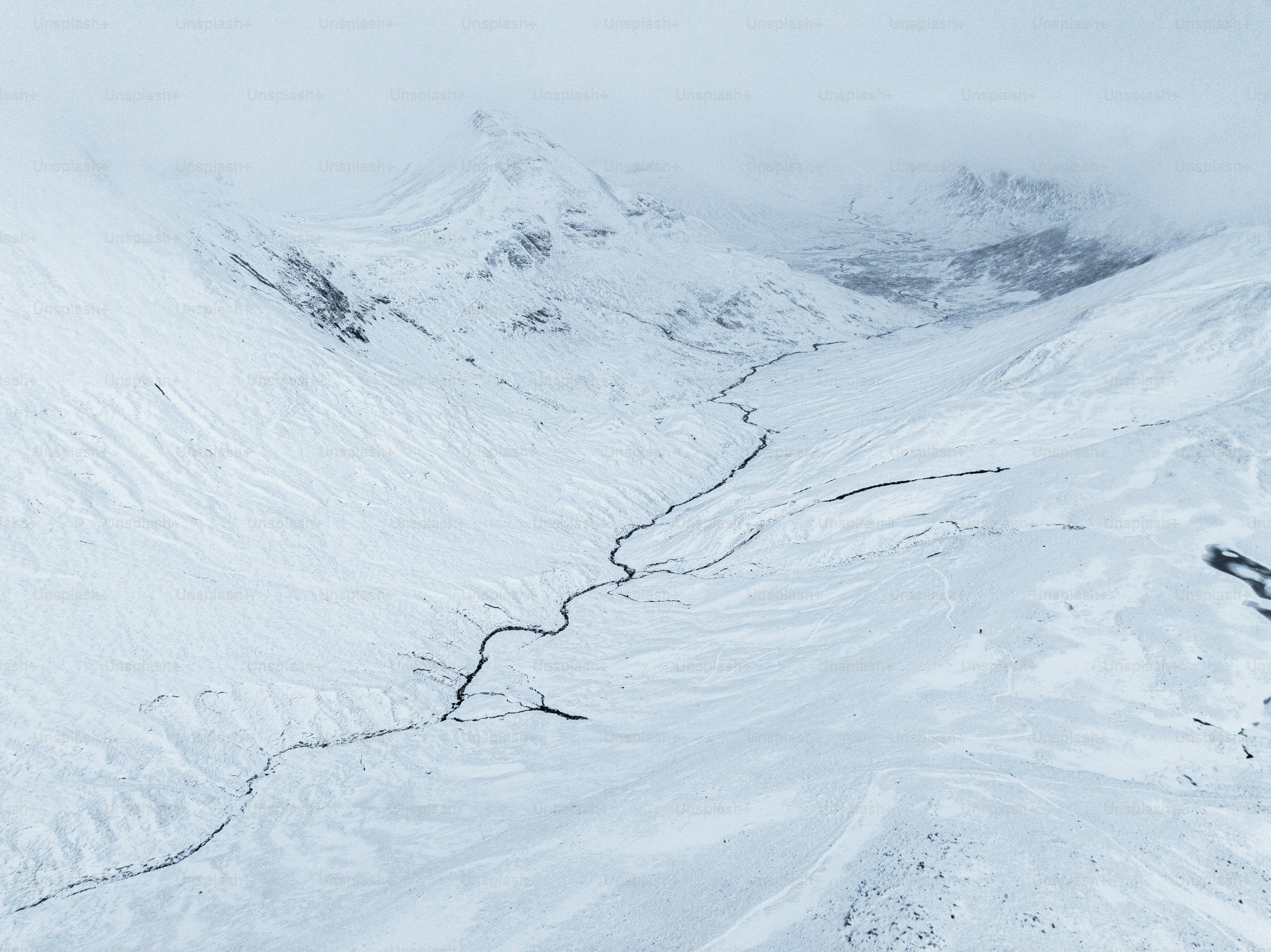 A man riding skis down a snow covered slope