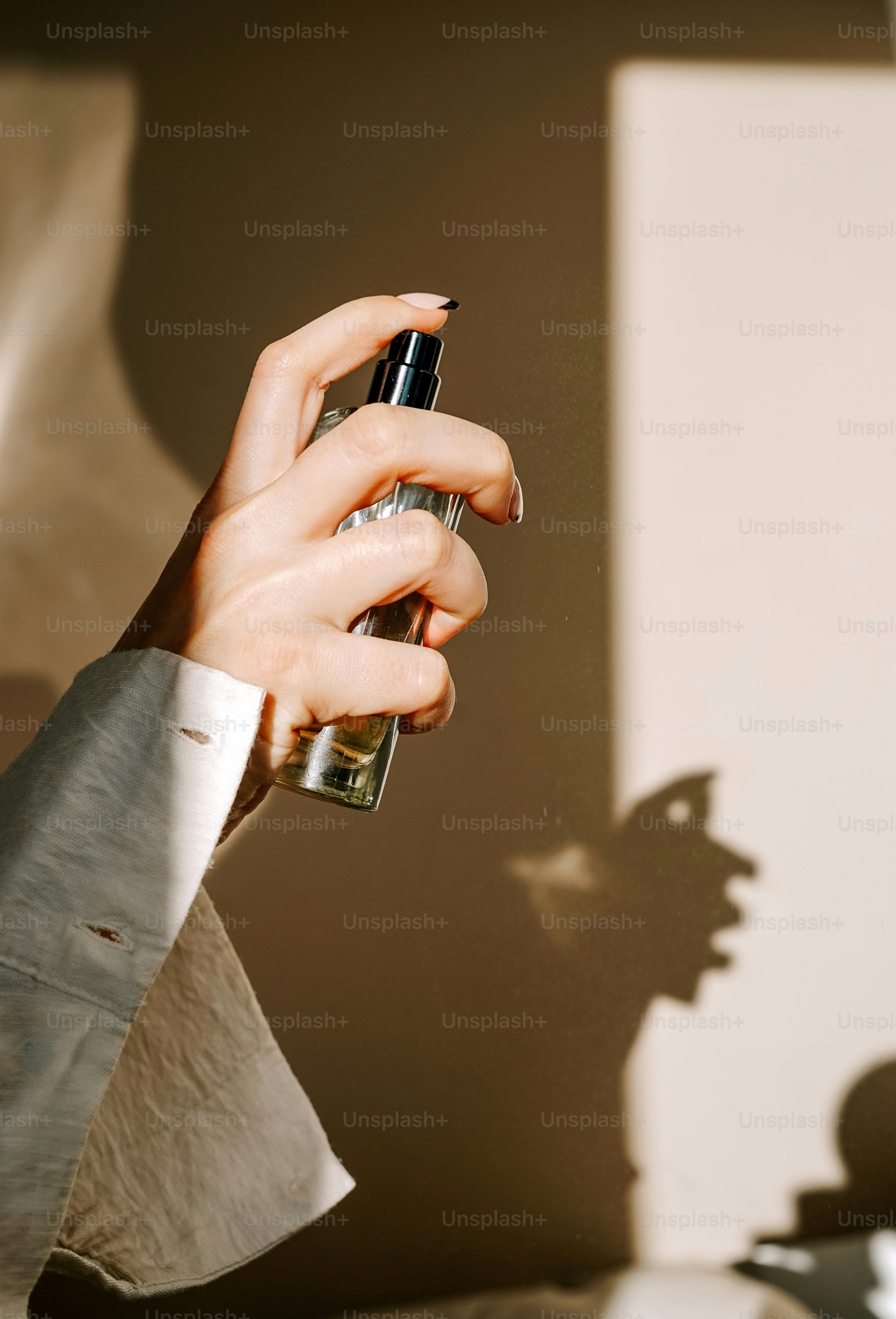 A person in a suit is holding a bottle