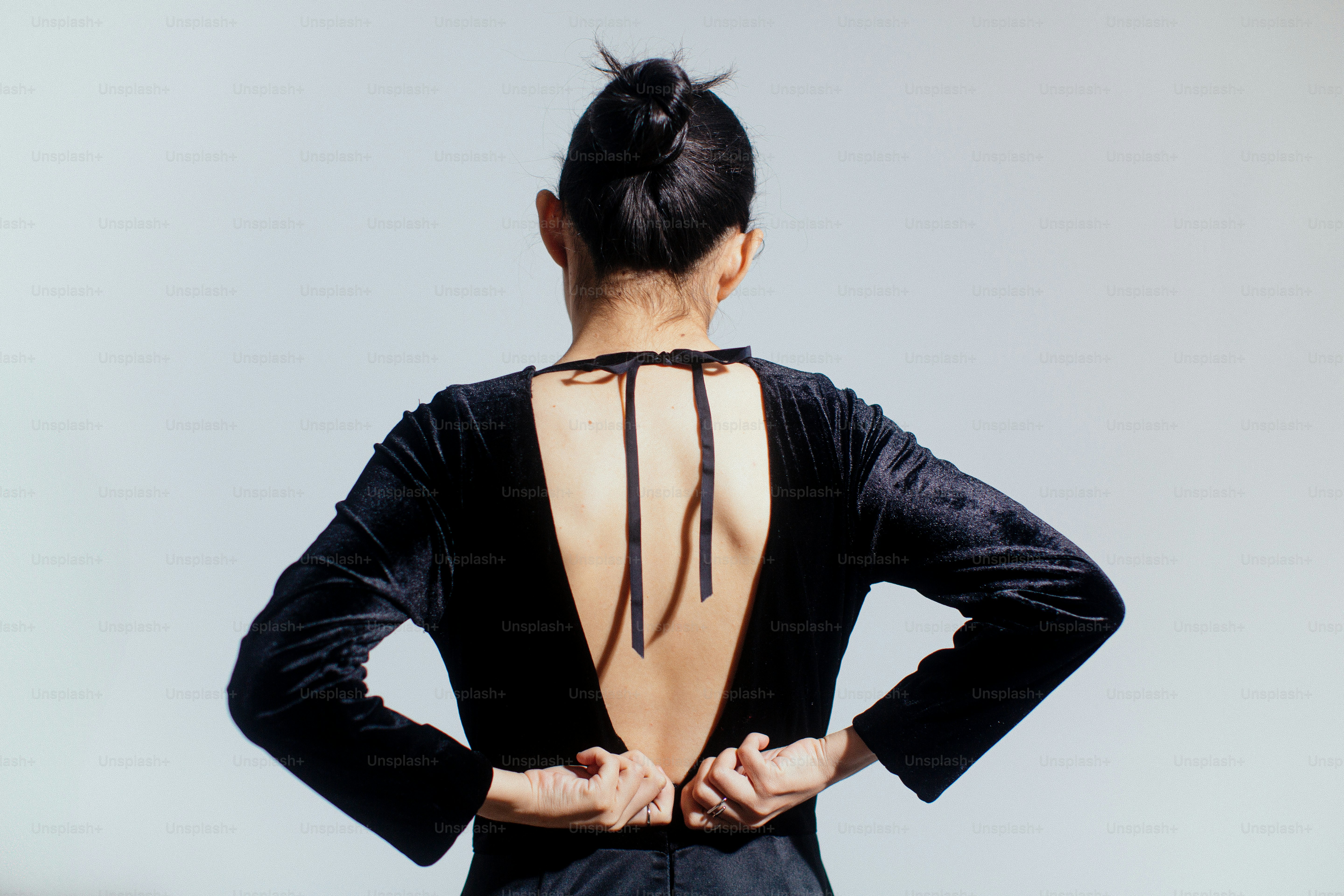 A woman standing with her back to the camera