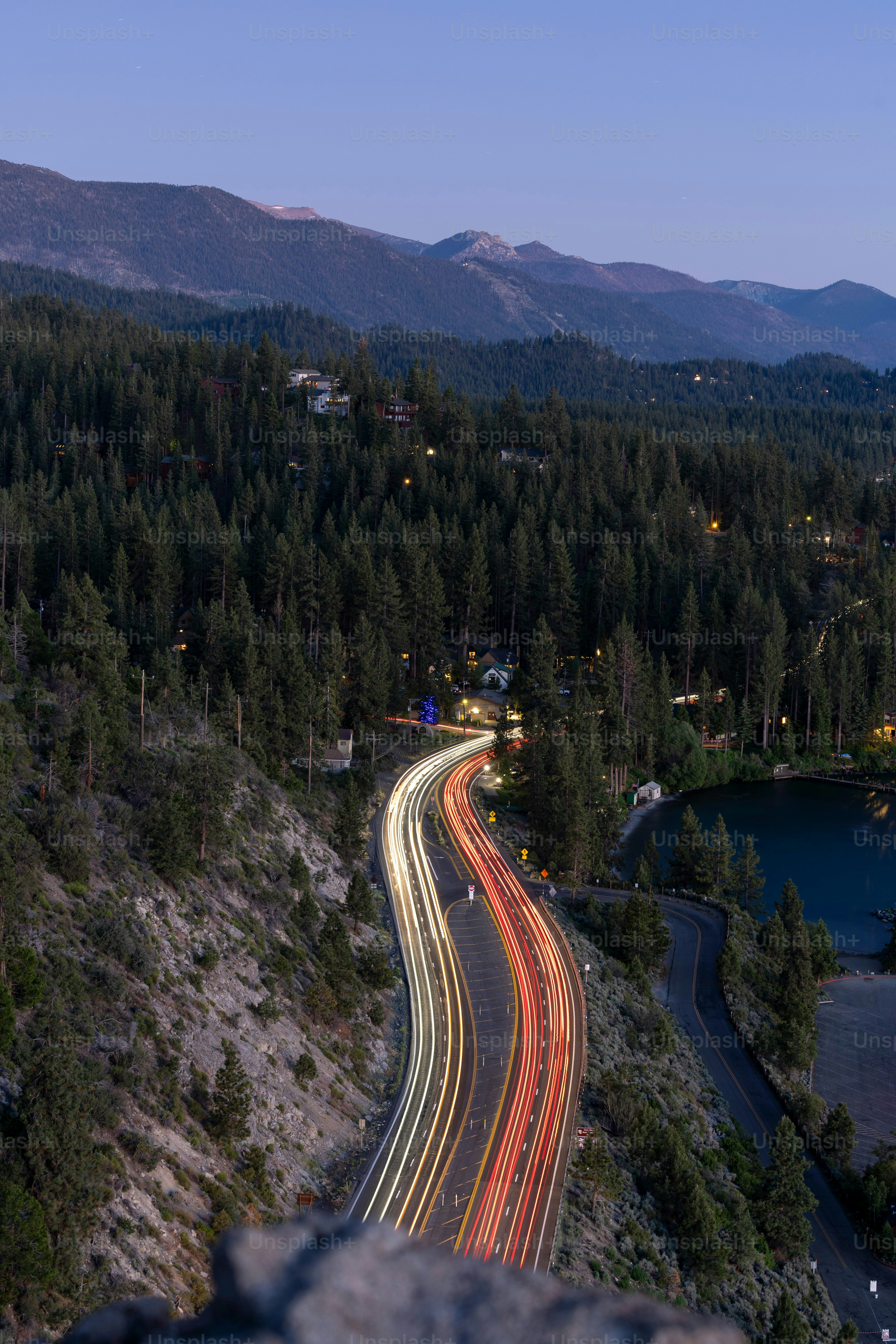 A long exposure shot of a highway going through the mountains